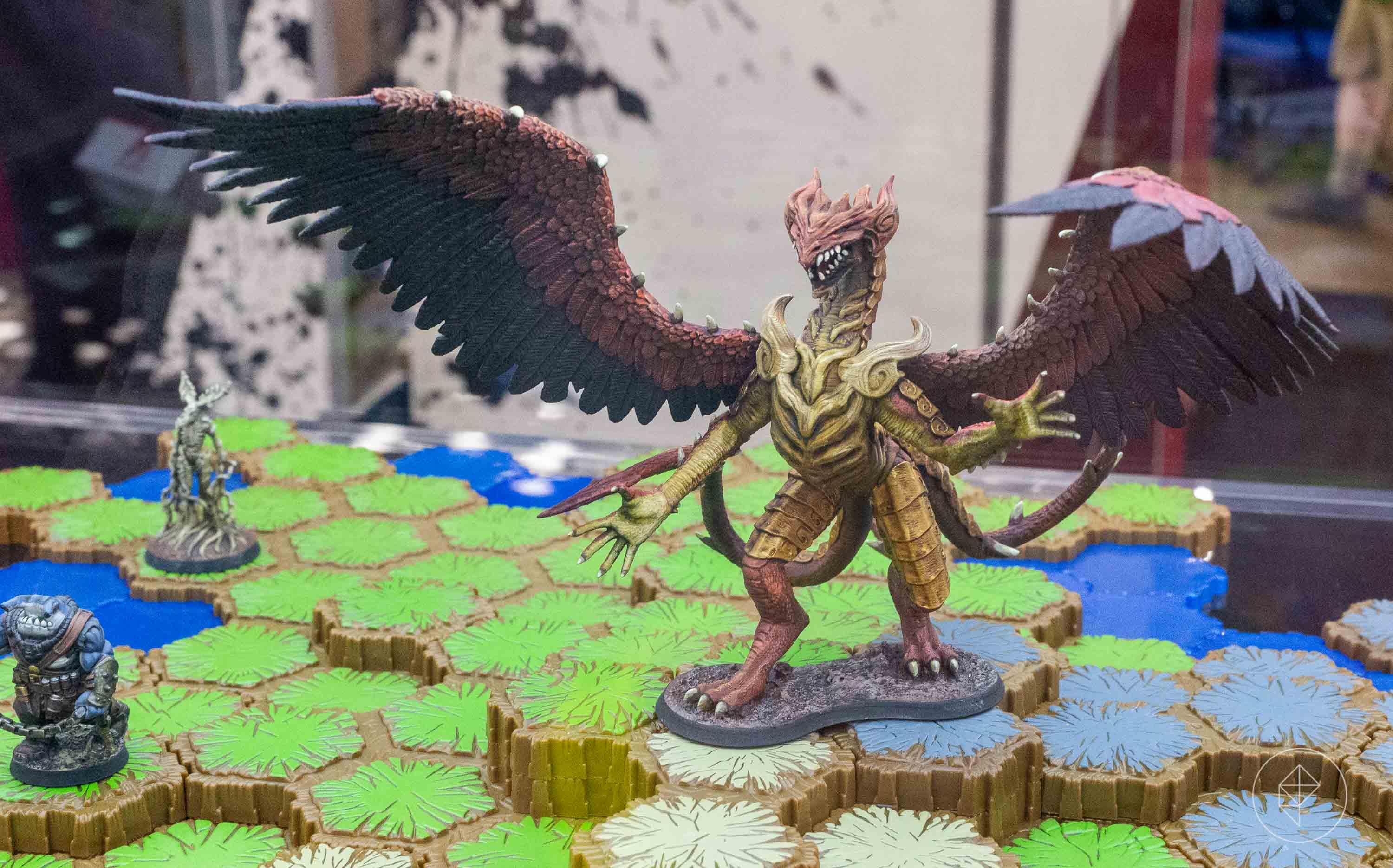 A dragon stands over a set of hex-shaped tiles.