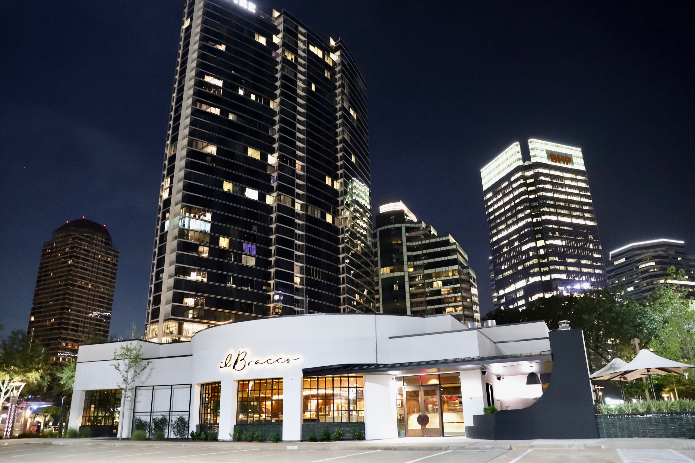 Il Bracco’s exterior lit up against the night sky.