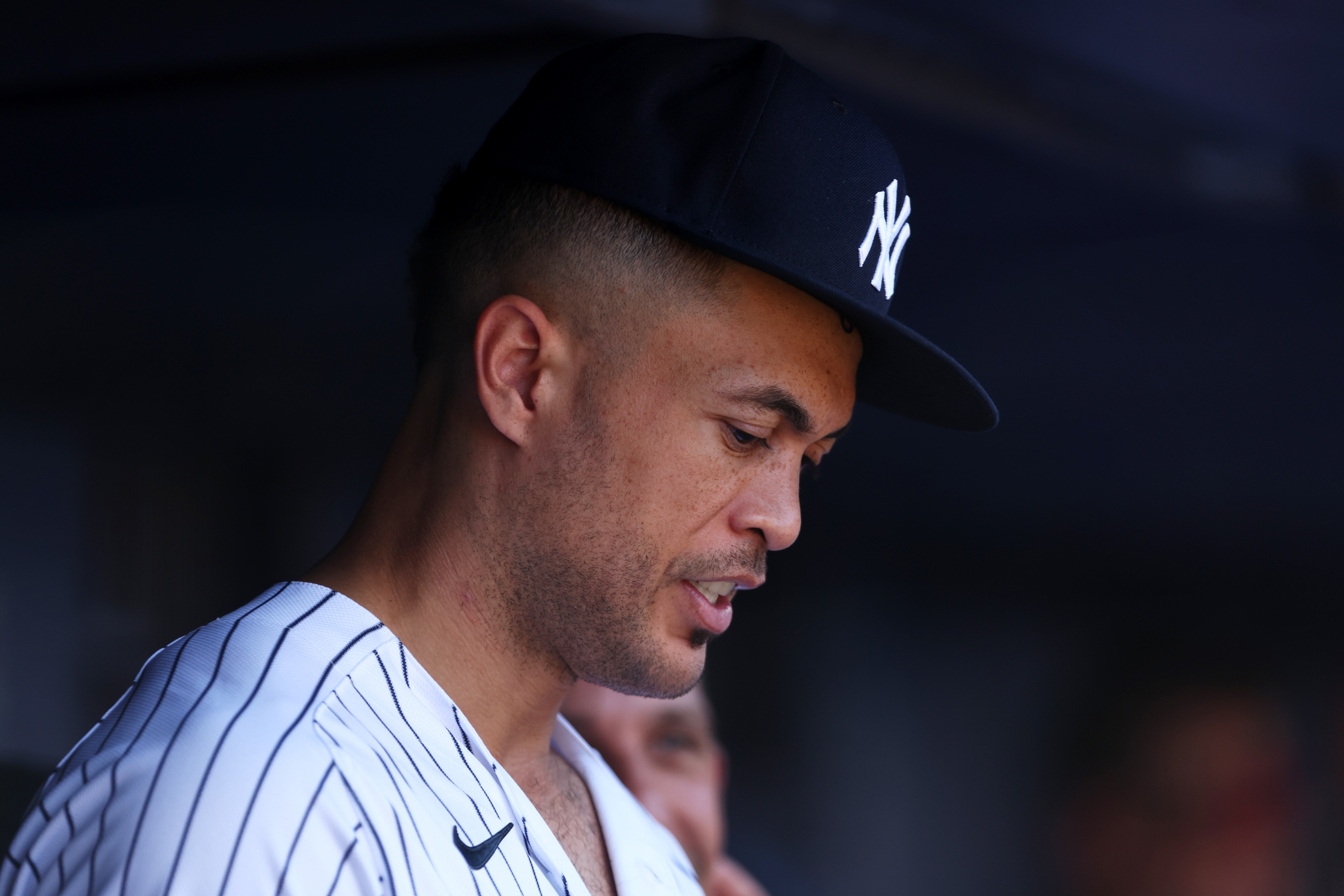 Giancarlo Stanton #27 of the New York Yankees watches from the dugout during a game against the Kansas City Royals at Yankee Stadium on July 30, 2022 in New York City.