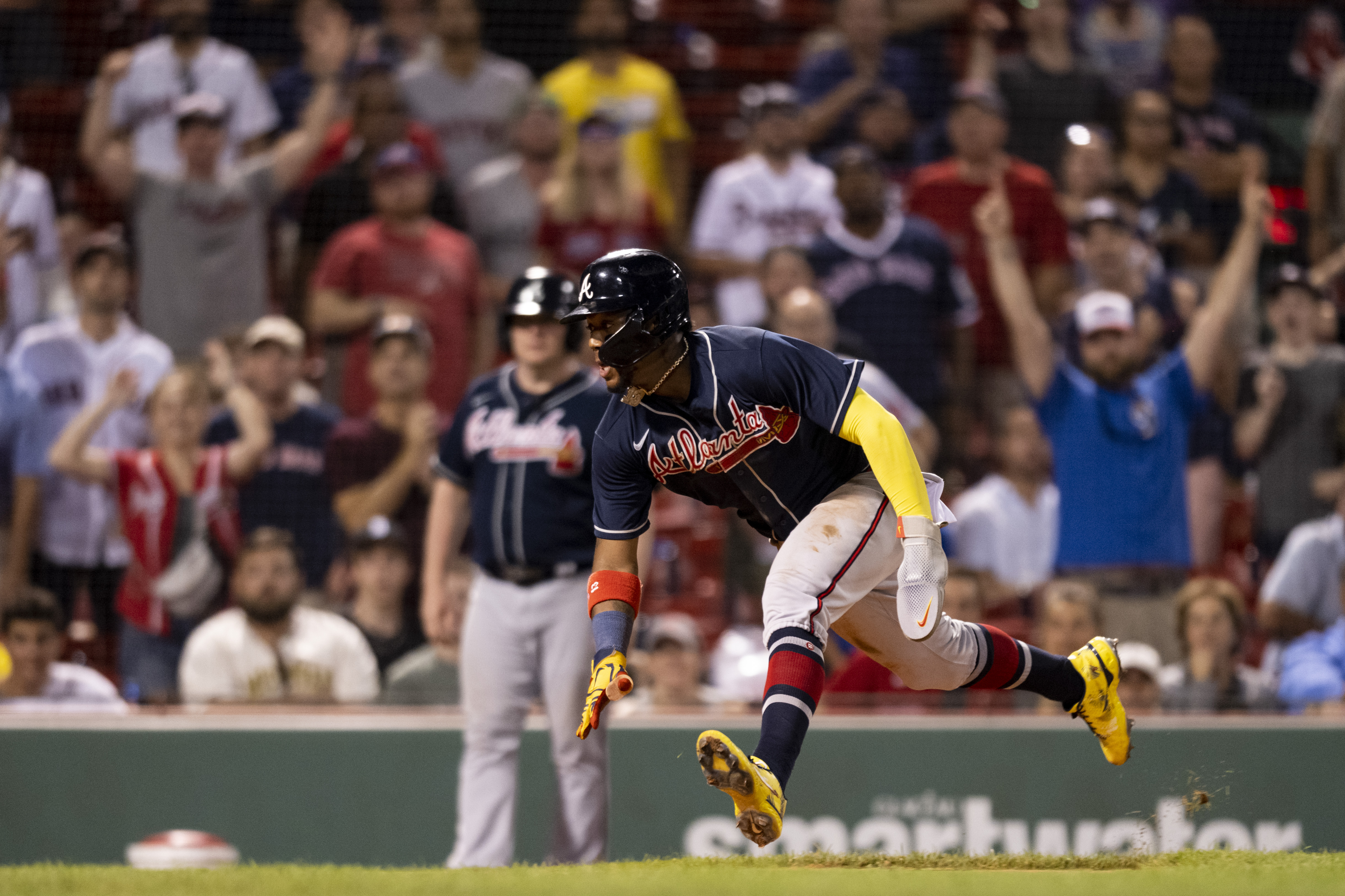 Ronald Acuna Jr. #13 of the Atlanta Braves slides as he scores during the eleventh inning of a game against the Boston Red Sox on August 9, 2022 at Fenway Park in Boston, Massachusetts.