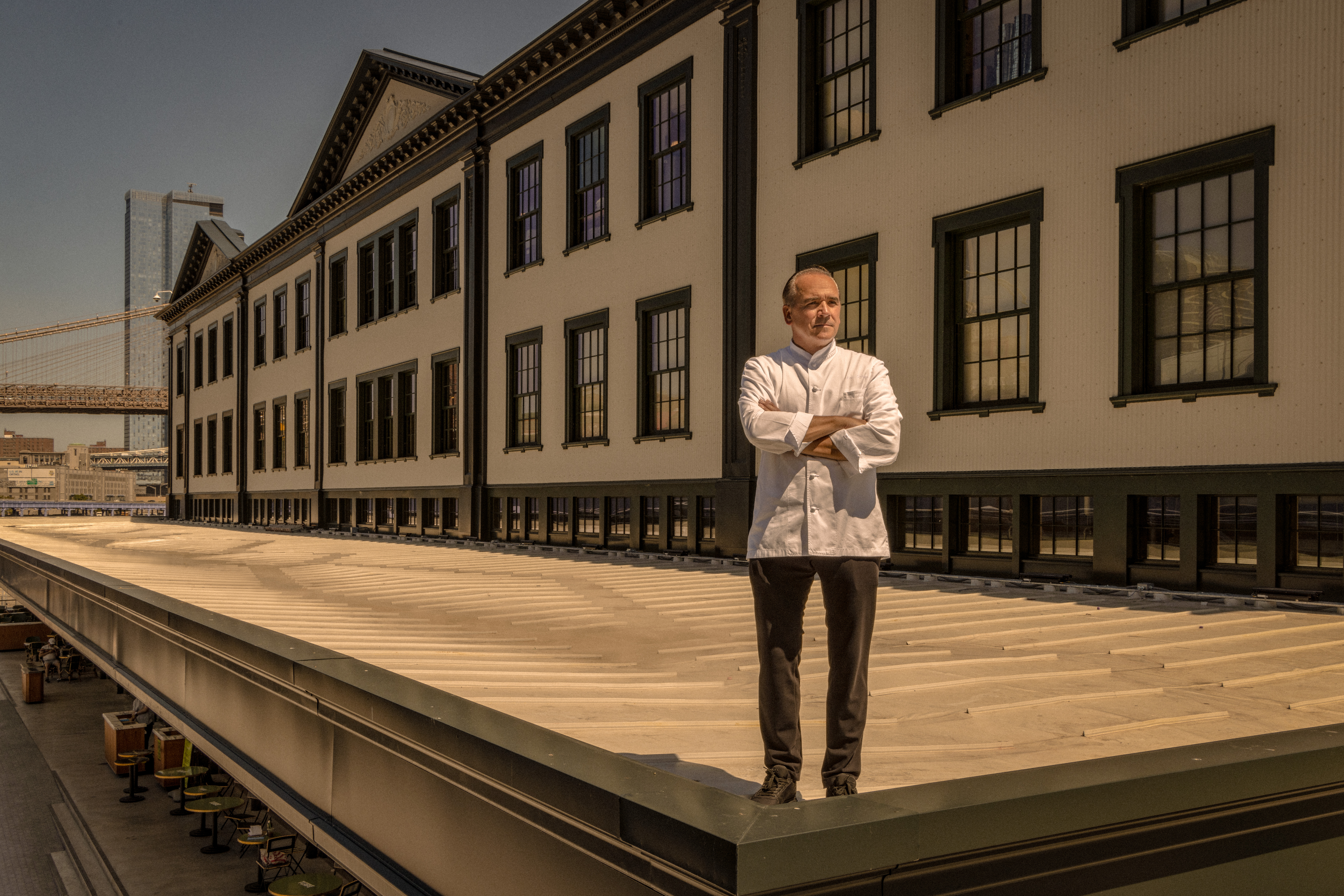 A chef stands on the roof of an historic building that used to be the epicenter of fish sales for the five boroughs.