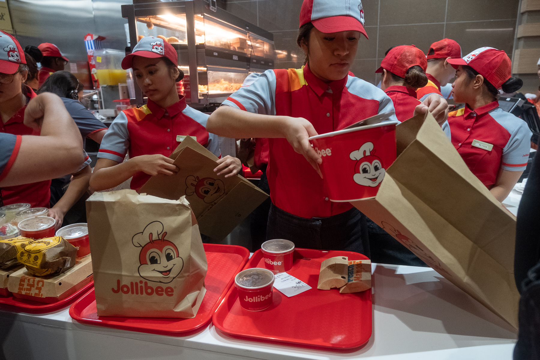 Workers package orders at a Manhattan location of Jollibee, a Filipino fast food chain.