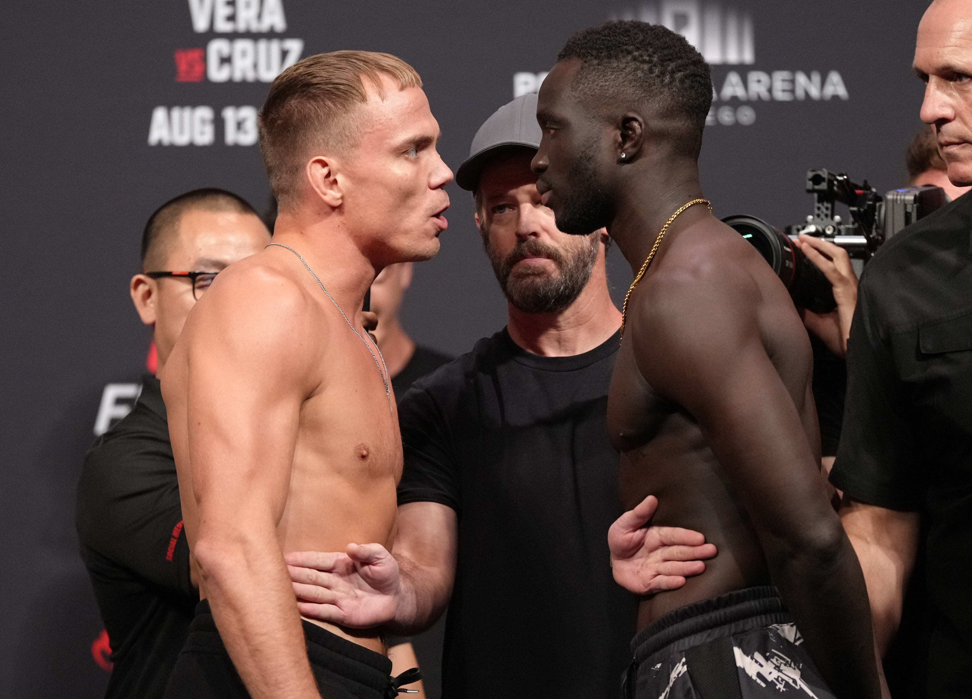 Opponents Nate Landwehr and David Onama of Uganda face off during the UFC Fight Night ceremonial weigh-in at Pechanga Arena on August 12, 2022 in San Diego, California.