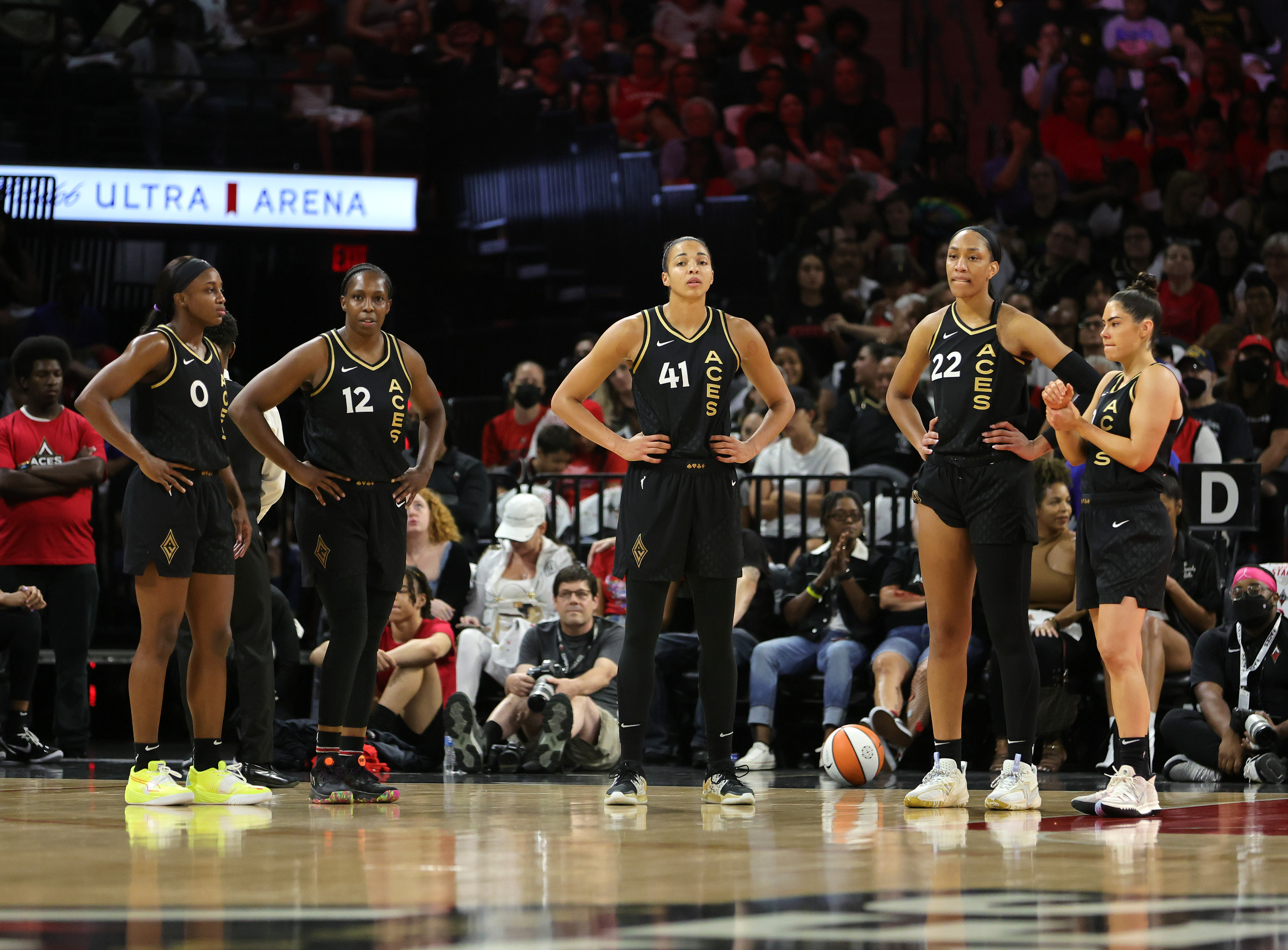 Jackie Young #0, Chelsea Gray #12, Kiah Stokes #41, A’ja Wilson #22 and Kelsey Plum #10 of the Las Vegas Aces stand on the court in the first quarter of Game Two of the 2022 WNBA Playoffs first round against the Phoenix Mercury at Michelob ULTRA Arena on August 20, 2022 in Las Vegas, Nevada. The Aces defeated the Mercury 117-80 to win the series.
