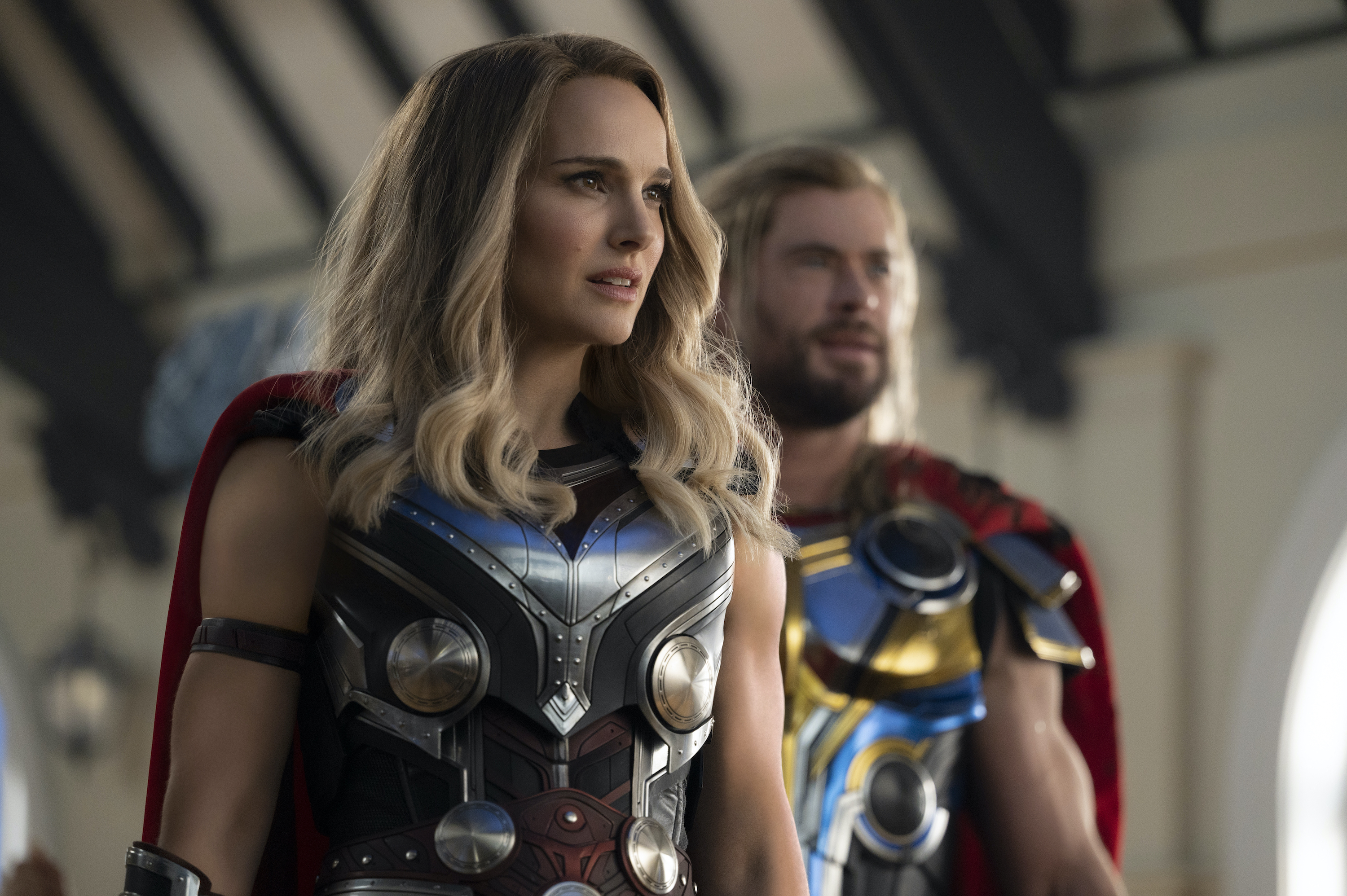 Natalie Portman as The Mighty Thor stands in front of Chris Hemsworth as Thor in Thor: Love and Thunder