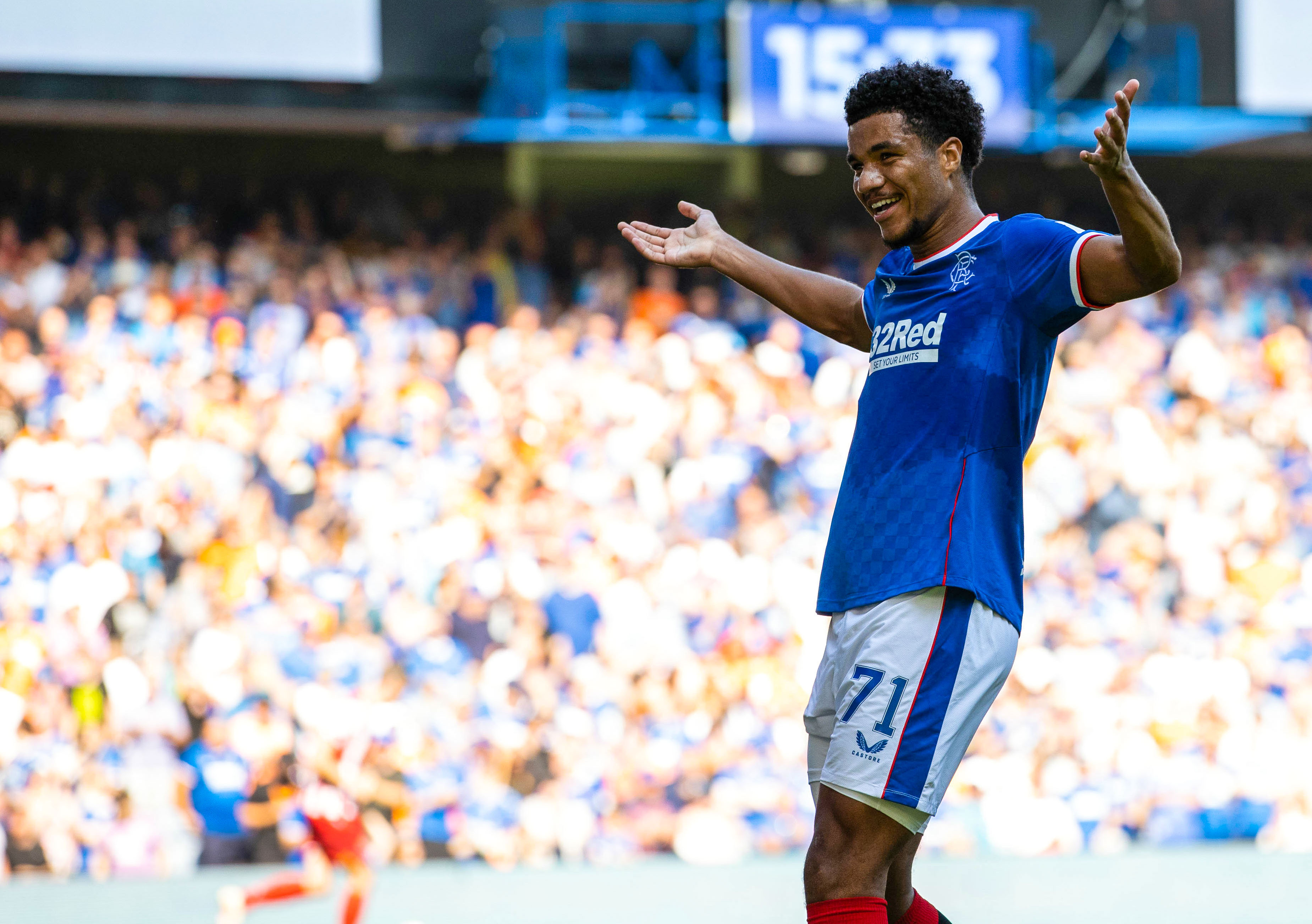Tillman holds up his arms as if to shrug, smiling, after his goal during Rangers FC v St. Johnstone FC - Cinch Scottish Premiership