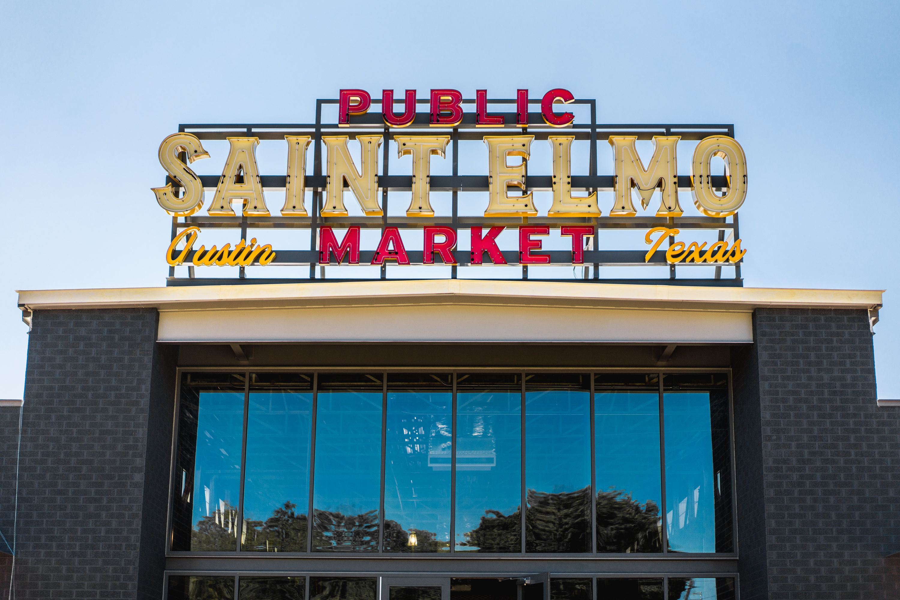 A sign that reads “Public Saint Elmo Market” on a building.