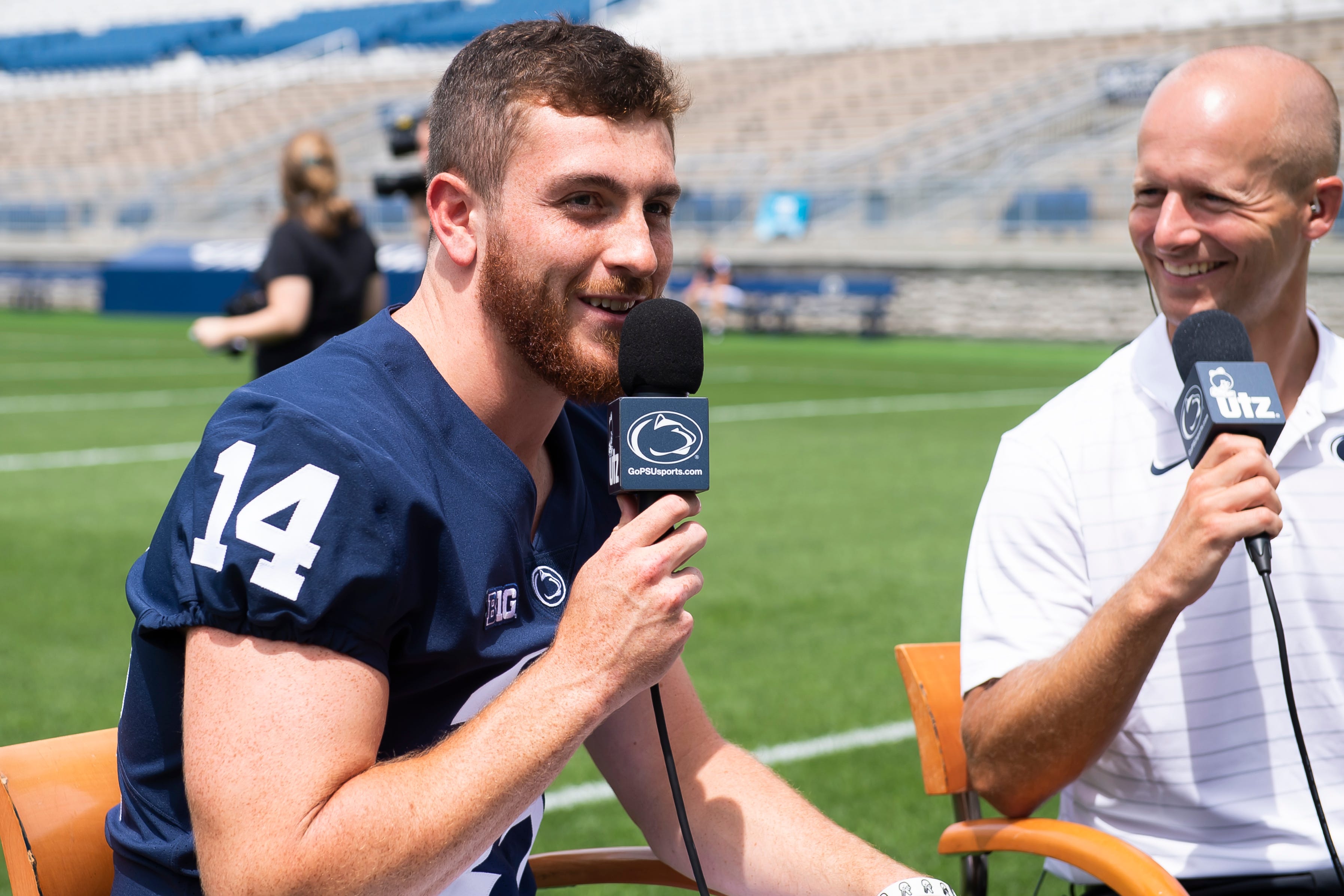 Sixth-year senior quarterback Sean Clifford smiles as he talks about one of his teammates standing in front of him during an interview at Penn State football media day in Beaver Stadium on Saturday, August 6, 2022