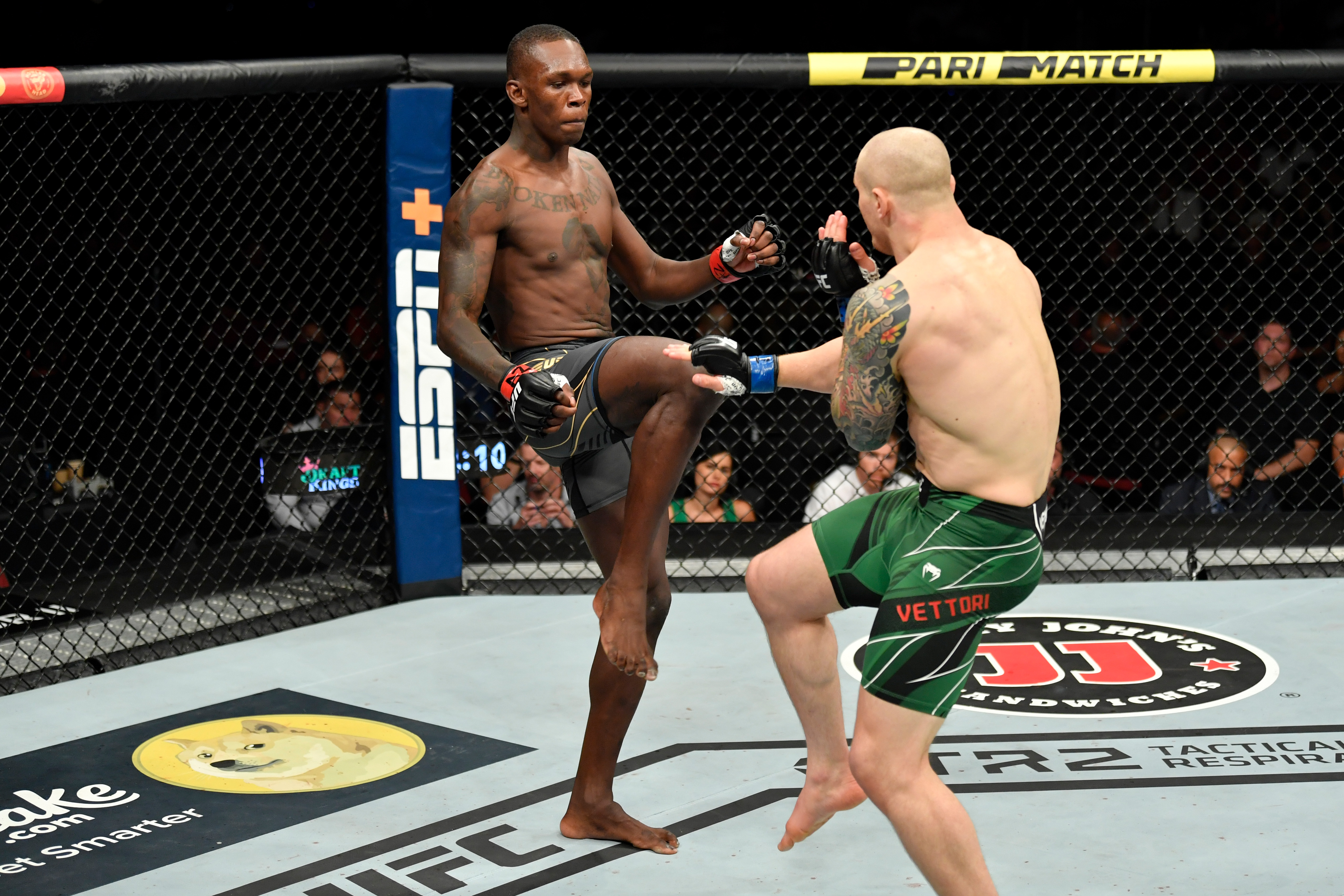 Israel Adesanya fires a kick at Marvin Vettori during their UFC 263 championship bout.