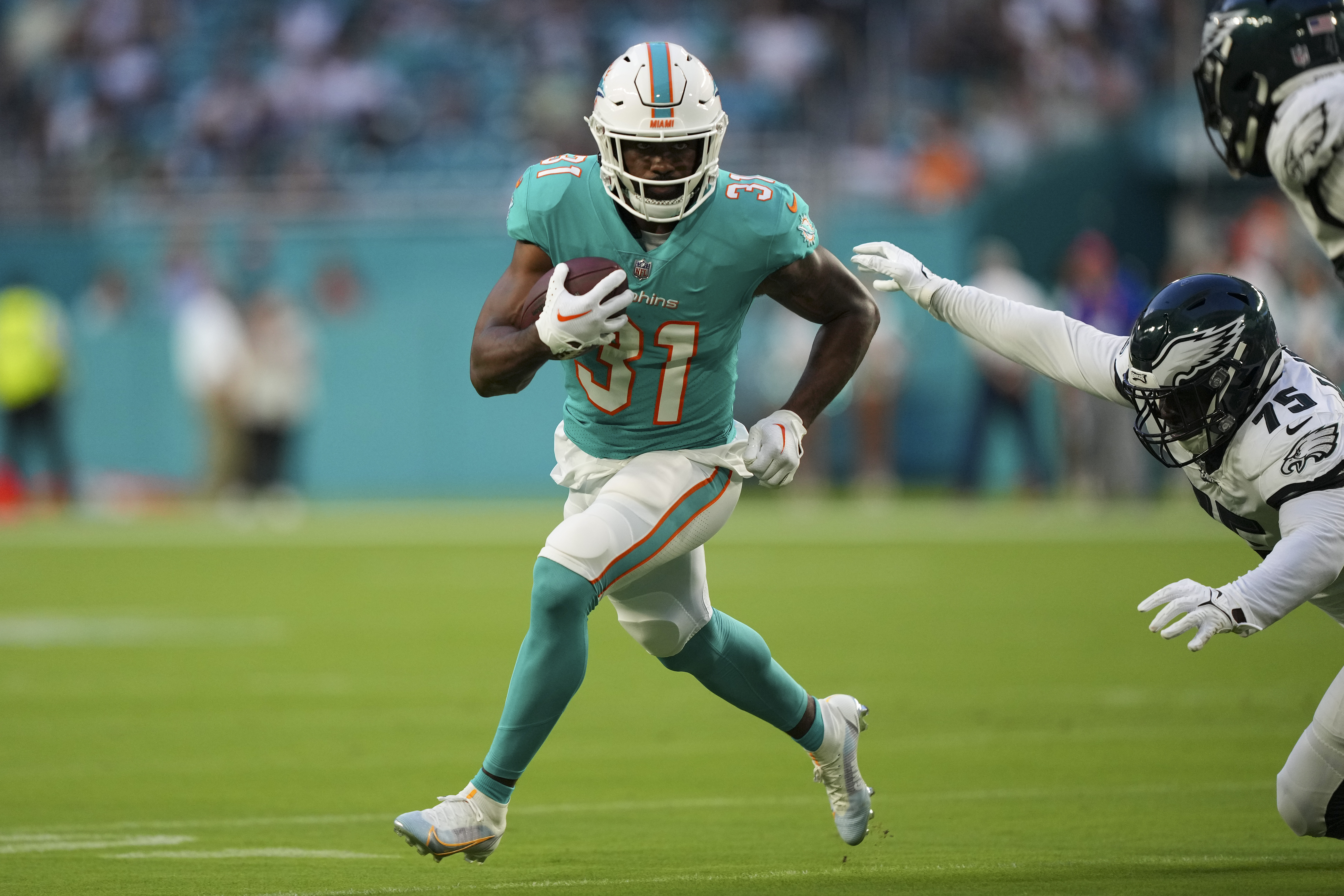 Raheem Mostert #31 of the Miami Dolphins rushes the football during the first quarter of the preseason game against the Philadelphia Eagles at Hard Rock Stadium on August 27, 2022 in Miami Gardens, Florida.