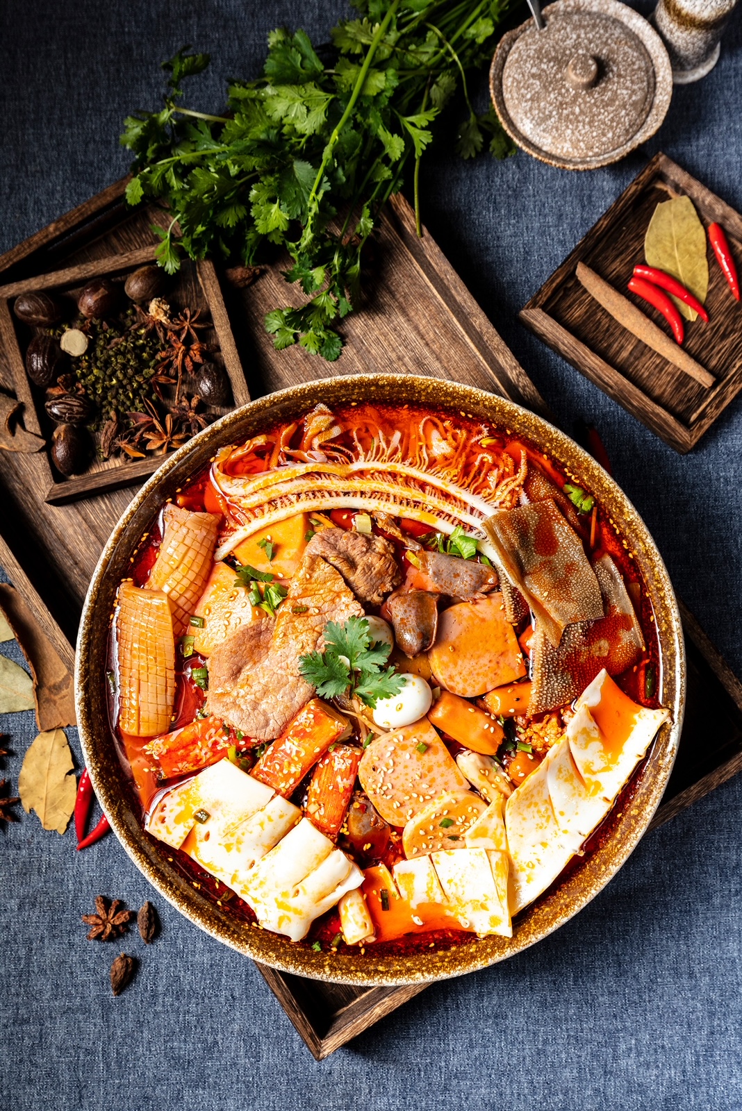 A bowl of hot pot with assorted ingredients.