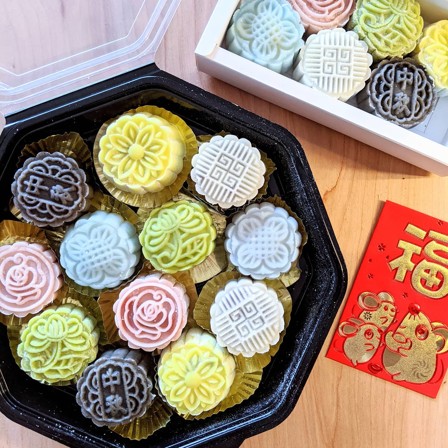 A container of pastel-colored mooncakes.