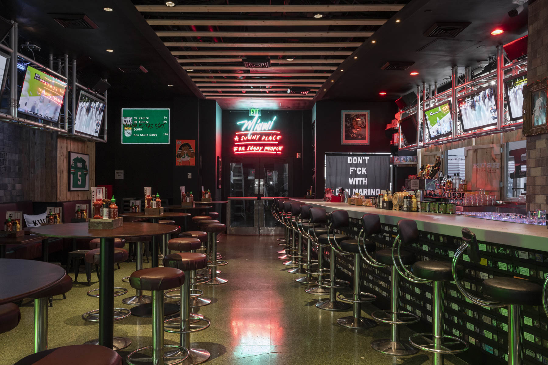 sports bar with TVs and large bar area.