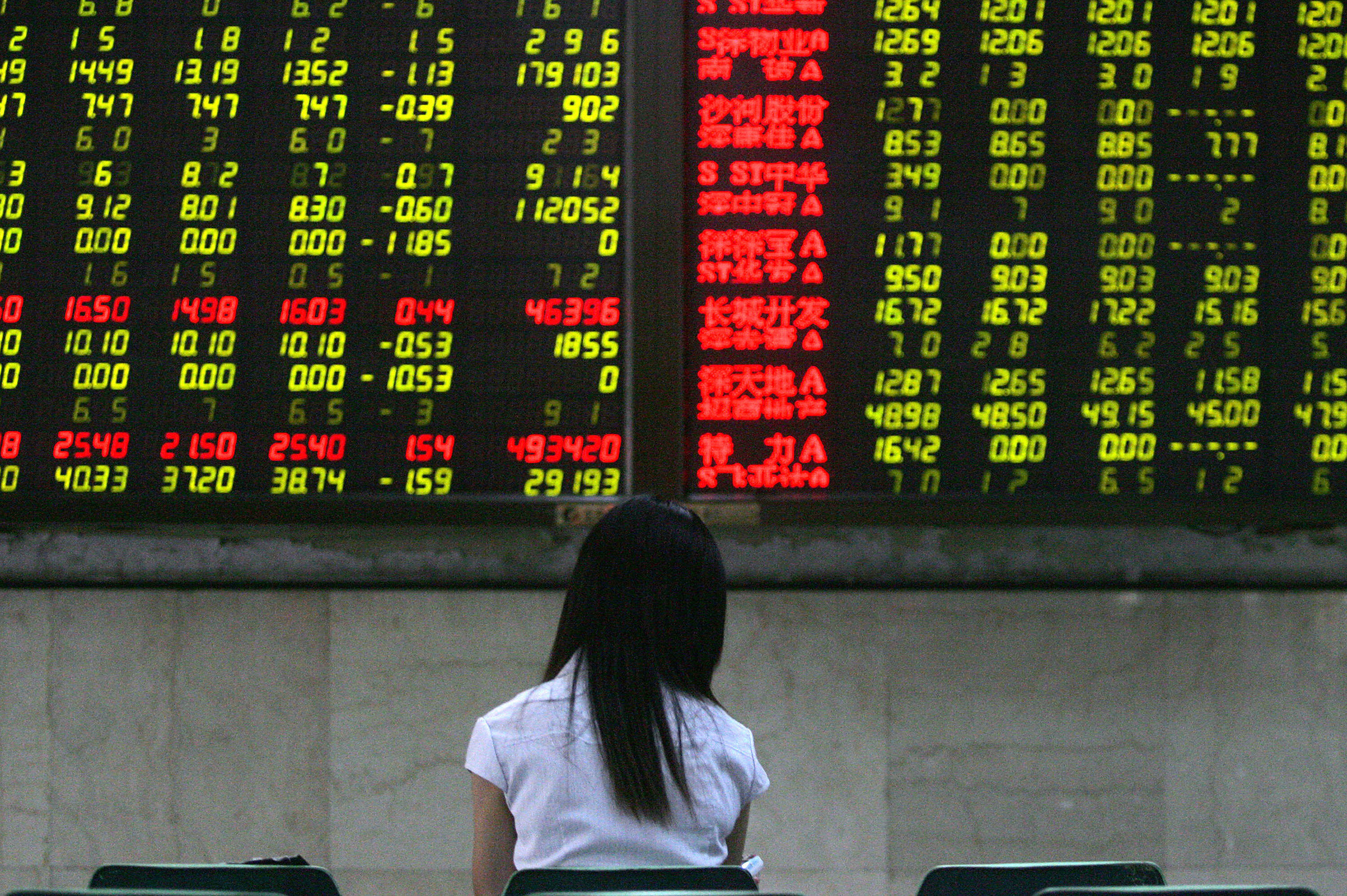 A Chinese stock investor checks his stoc...