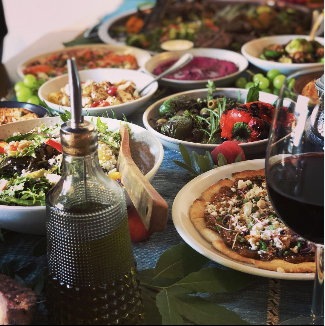 A bunch of Levantine salads and dips on a table.