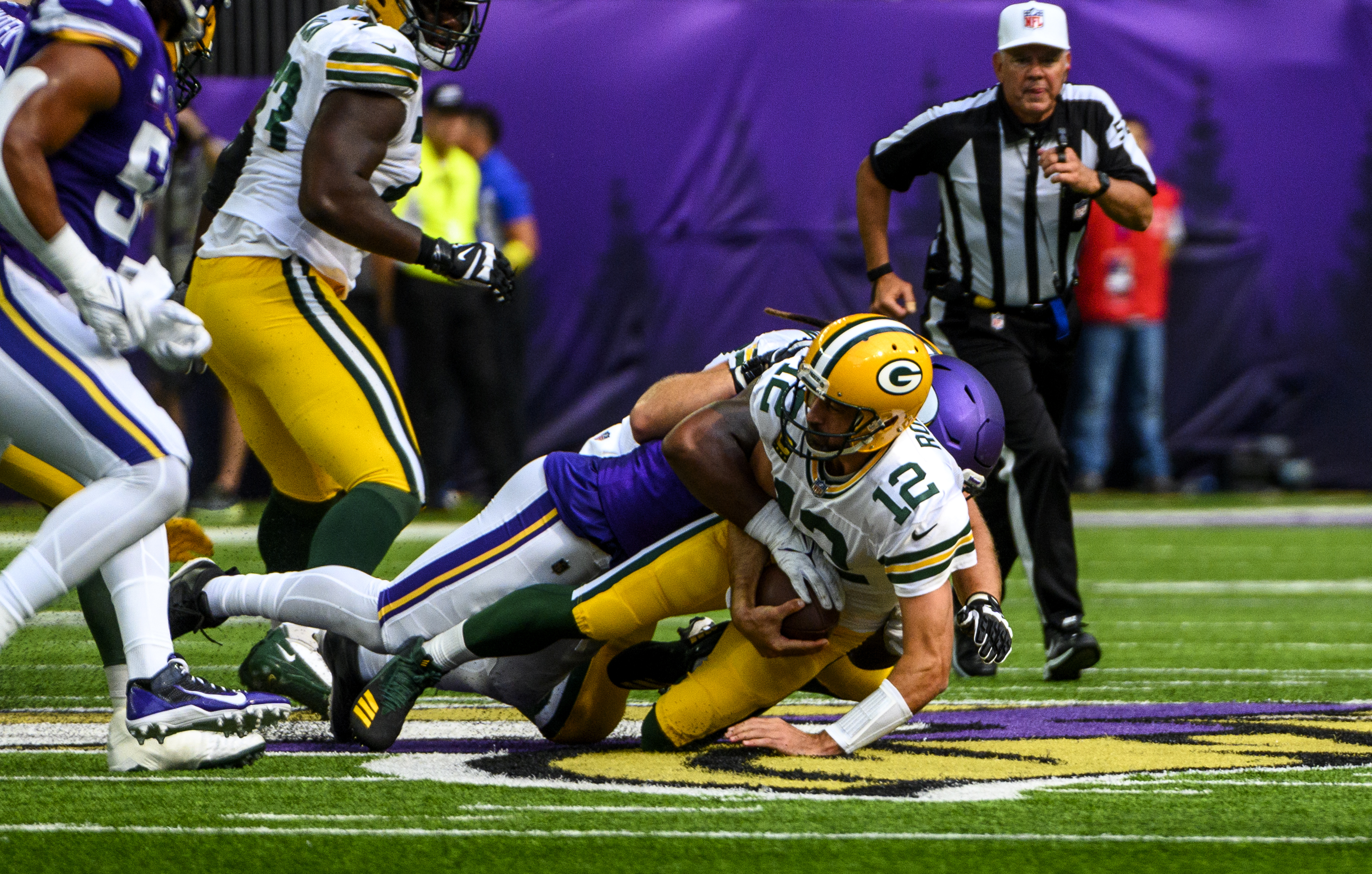 Aaron Rodgers #12 of the Green Bay Packers is sacked by Za’Darius Smith #55 of the Minnesota Vikings in the first quarter of the game at U.S. Bank Stadium on September 11, 2022 in Minneapolis, Minnesota.