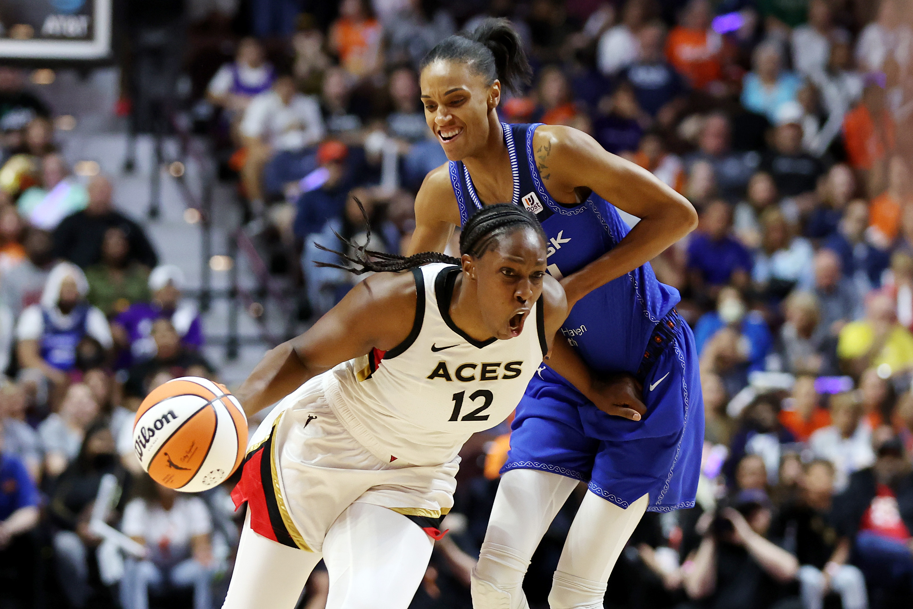 Chelsea Gray #12 of the Las Vegas Aces dribbles against DeWanna Bonner #24 of the Connecticut Sun in the first half during game four of the 2022 WNBA Finals at Mohegan Sun Arena on September 18, 2022 in Uncasville, Connecticut.