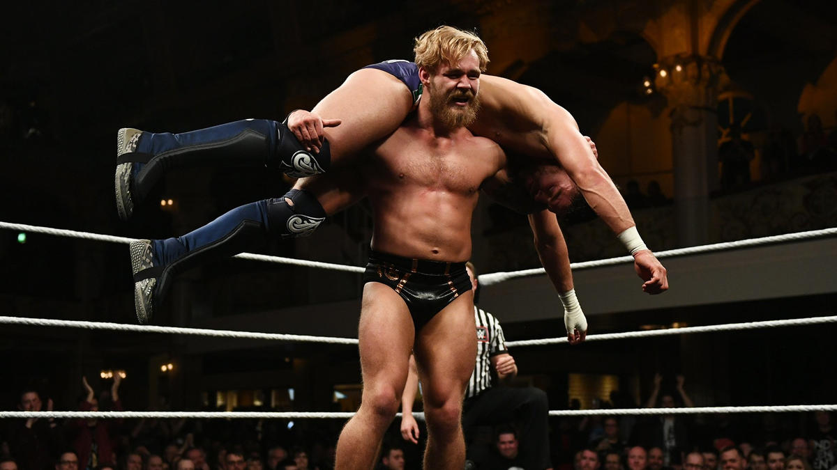 Tyler Bate has JD McDonagh in a fireman’s carry back in NXT UK