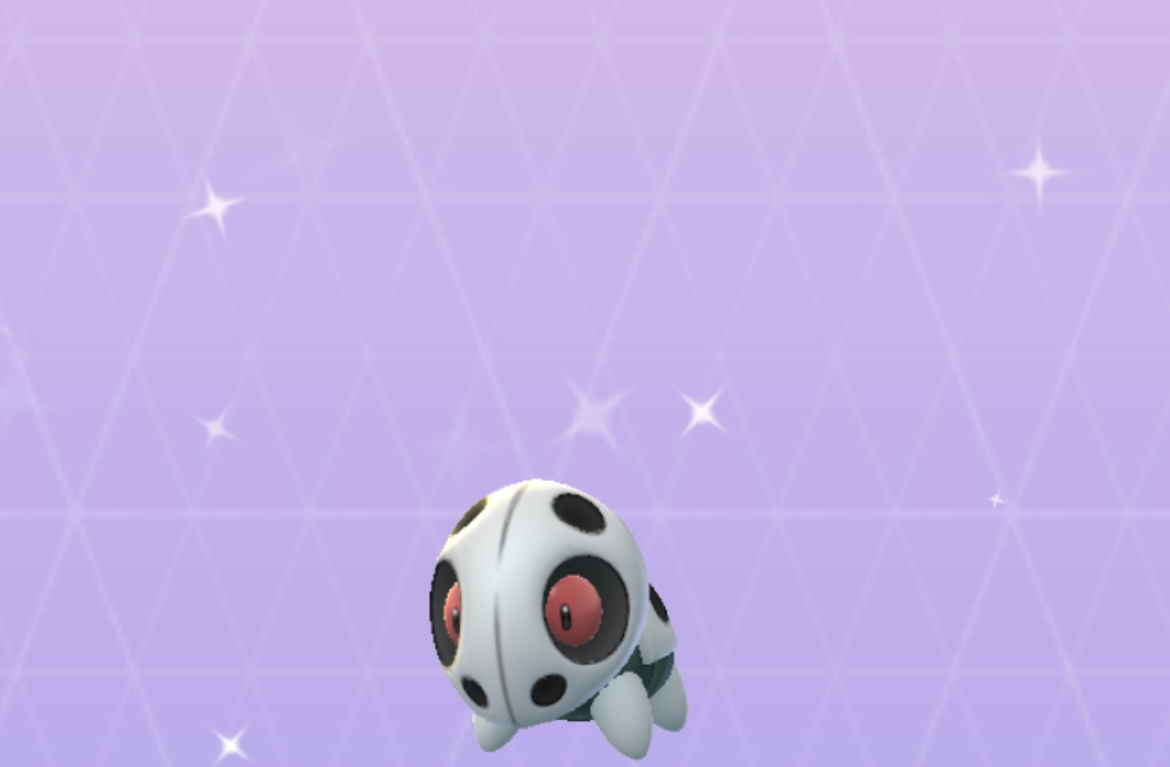 Shiny Aron with its red eyes on a purple Pokémon Go background