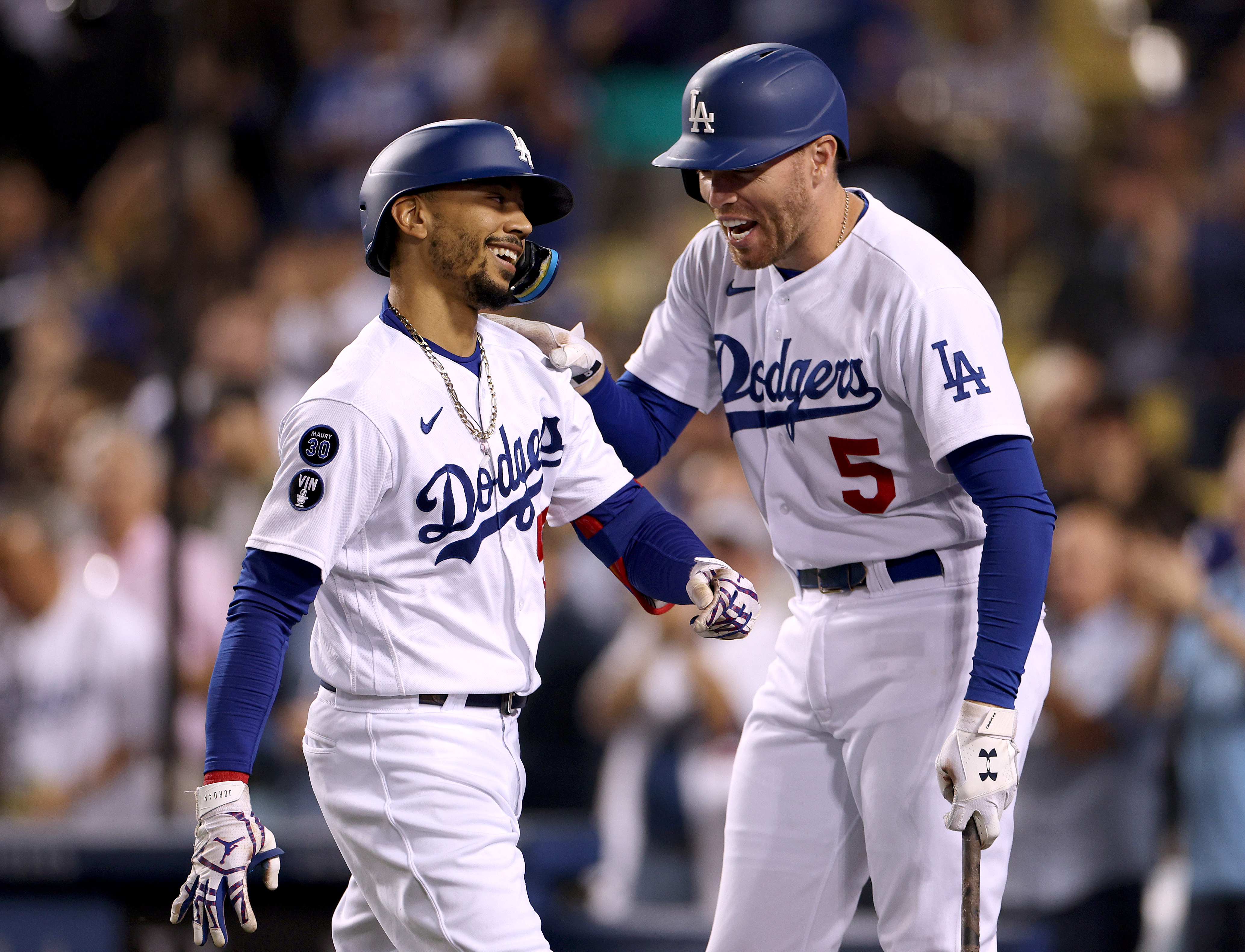 LOS ANGELES, CALIFORNIA - SEPTEMBER 21: Mookie Betts #50 of the Los Angeles Dodgers celebrates his solo homerun with Freddie Freeman #5, to trail the Arizona Diamondbacks 5-1, during the fourth inning at Dodger Stadium on September 21, 2022 in Los Angeles, California.