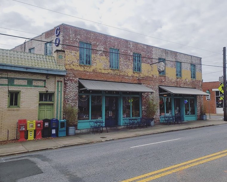 The faded brick exterior of the two story building in which vegetarian and vegan restaurant the Grit resides in Athens, GA. 