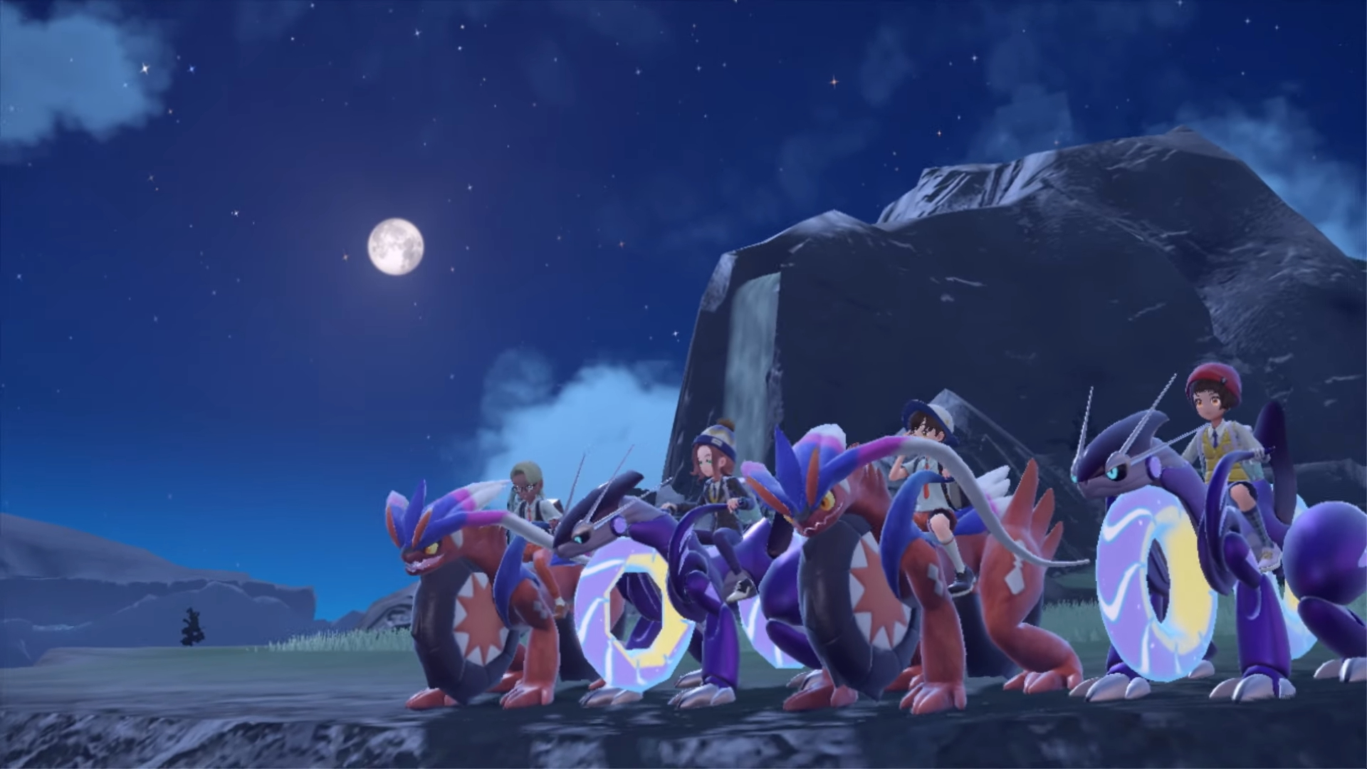 A group of four players, and each is riding a Legendary Pokémon (either Koraidon or Miraidon) in their motorcycle forms.