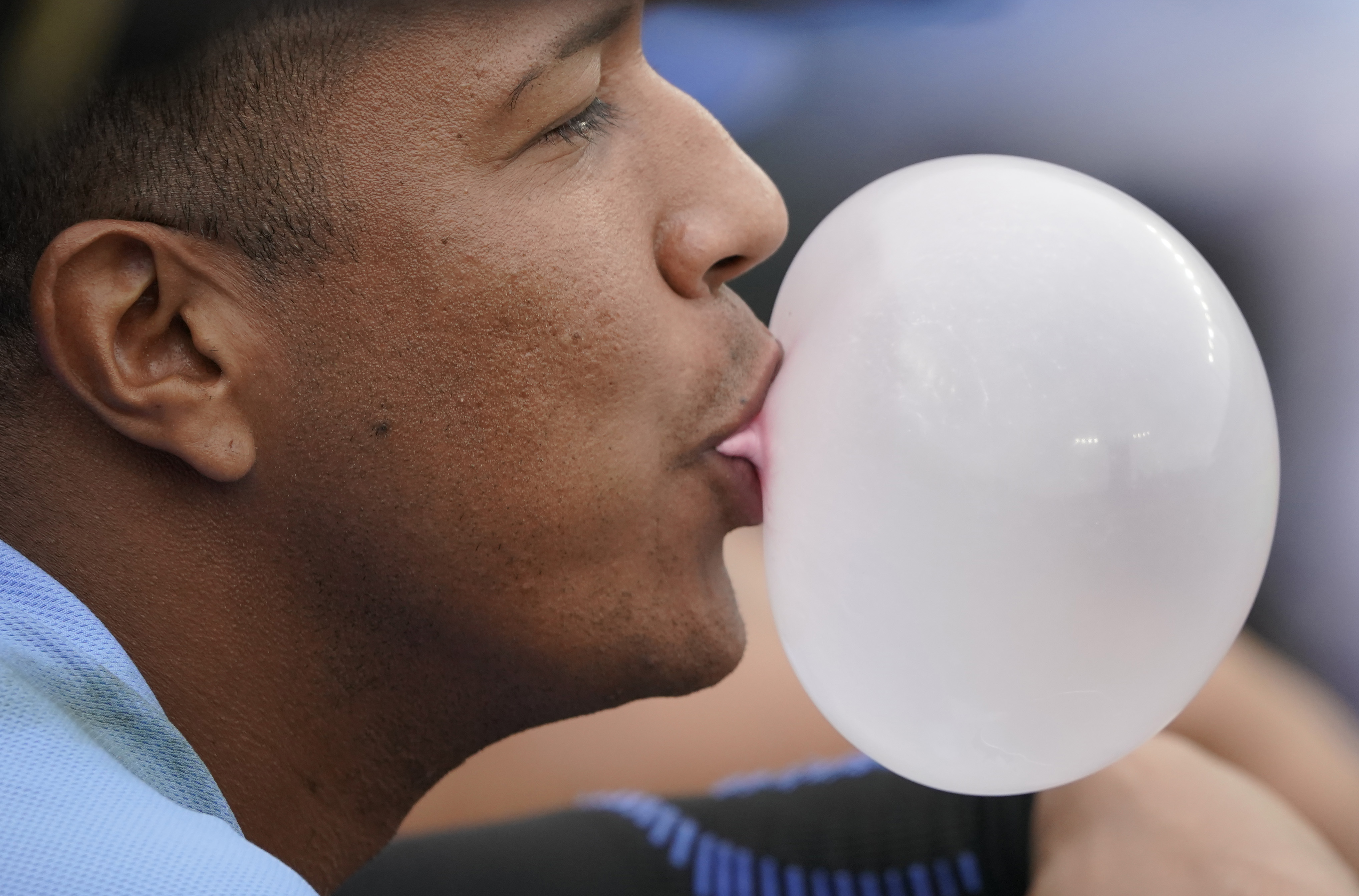 Salvador Perez #13 of the Kansas City Royals blows a bubble during the ninth inning during a game against the Minnesota Twins at Kauffman Stadium on September 22, 2022 in Kansas City, Missouri.