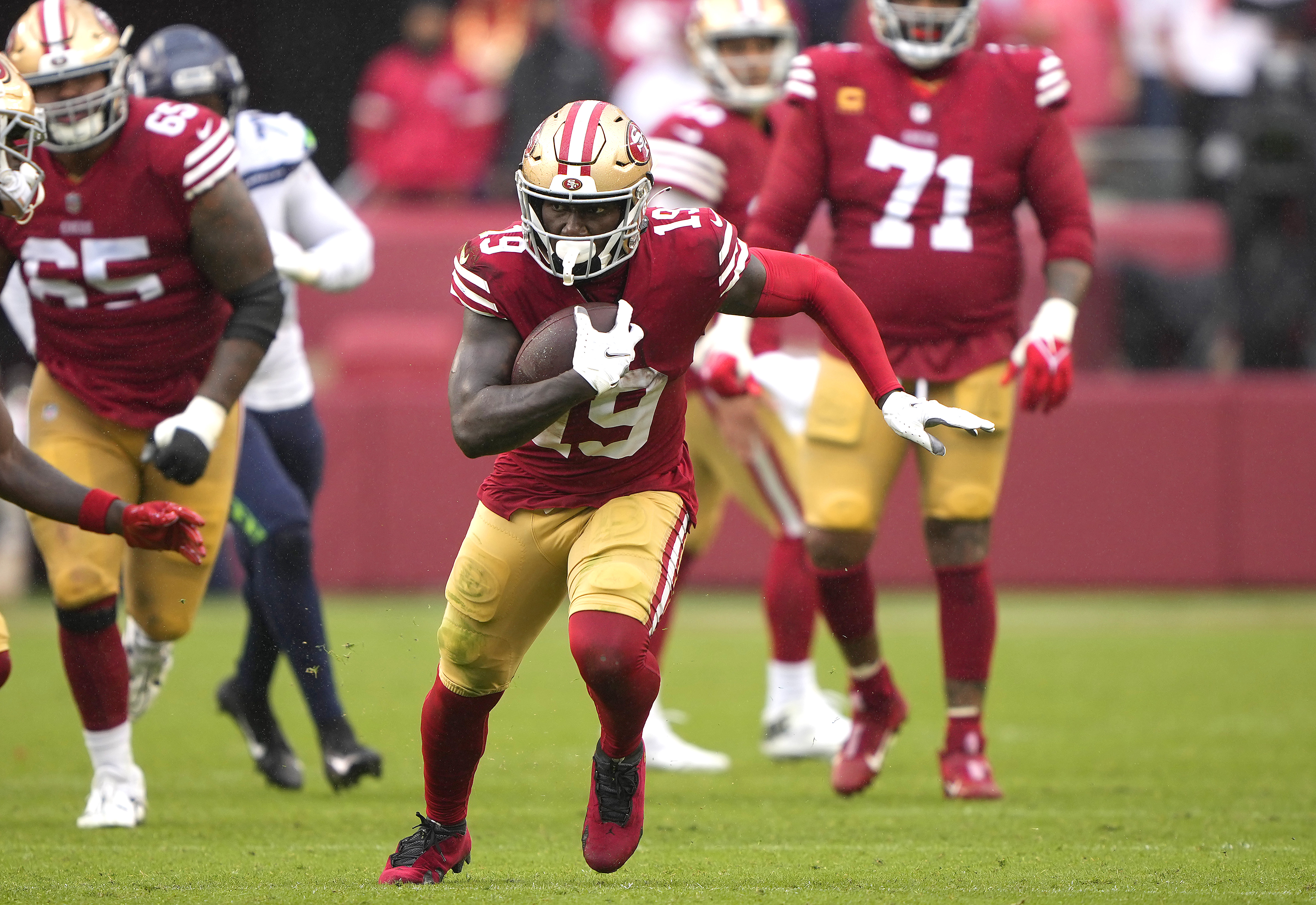 Deebo Samuel #19 of the San Francisco 49ers runs with the ball after making a catch against the Seattle Seahawks during the second half at Levi’s Stadium on September 18, 2022 in Santa Clara, California.