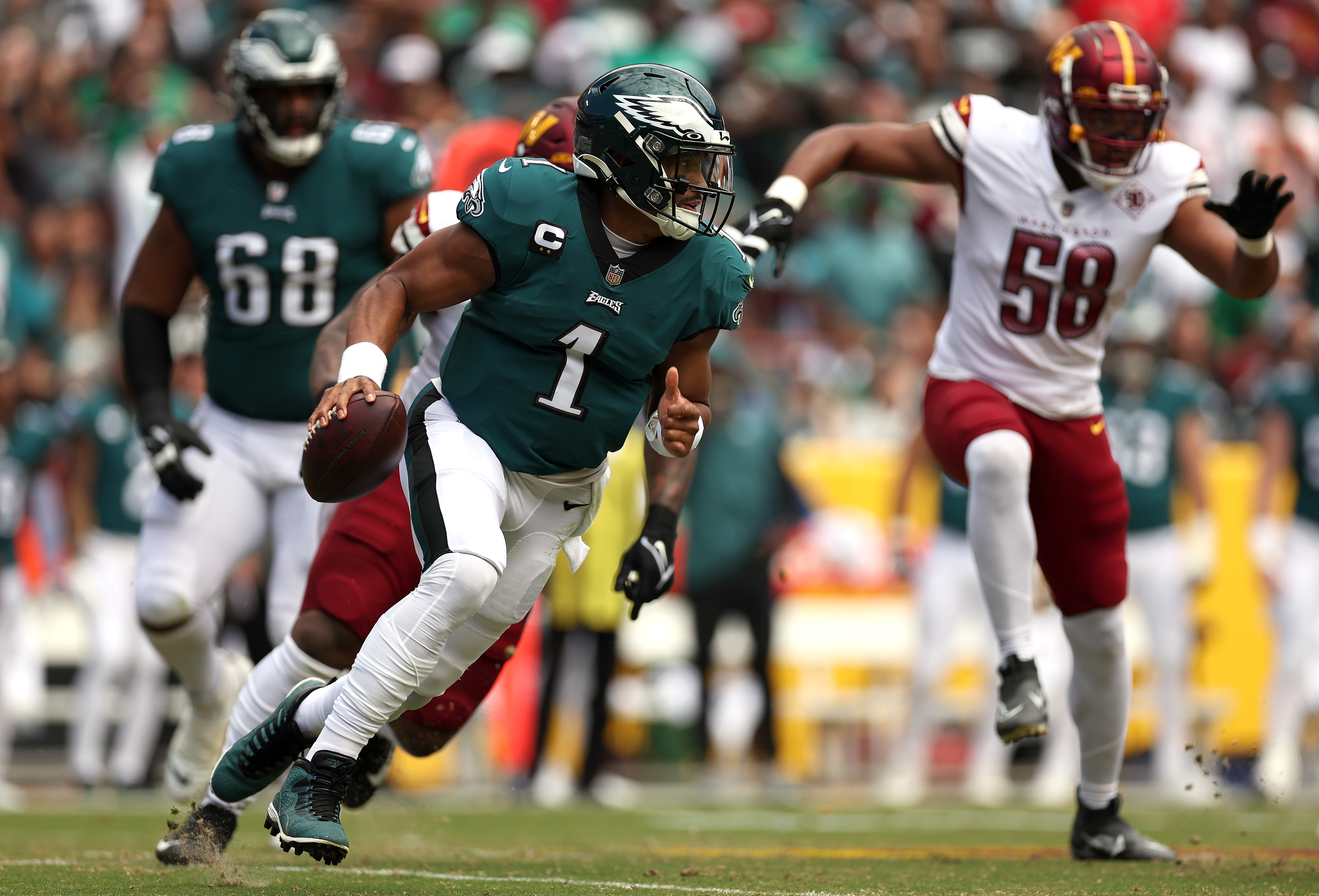 Quarterback Jalen Hurts #1 of the Philadelphia Eagles scrambles during the first half at FedExField on September 25, 2022 in Landover, Maryland.