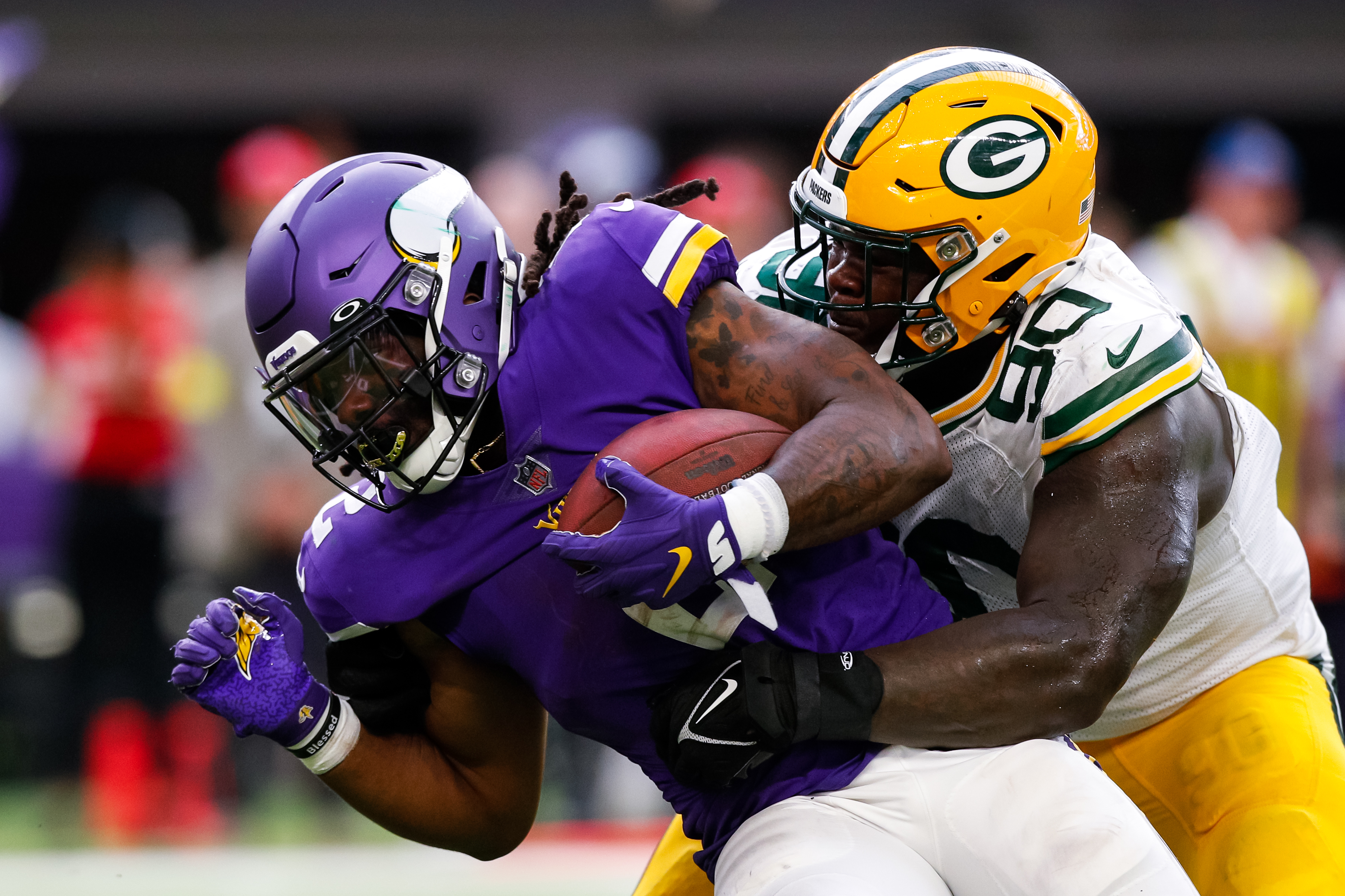 Alexander Mattison #2 of the Minnesota Vikings is tackled by Jarran Reed #90 of the Green Bay Packers in the fourth quarter of the game at U.S. Bank Stadium on September 11, 2022 in Minneapolis, Minnesota. The Vikings defeated the Packers 23-7.