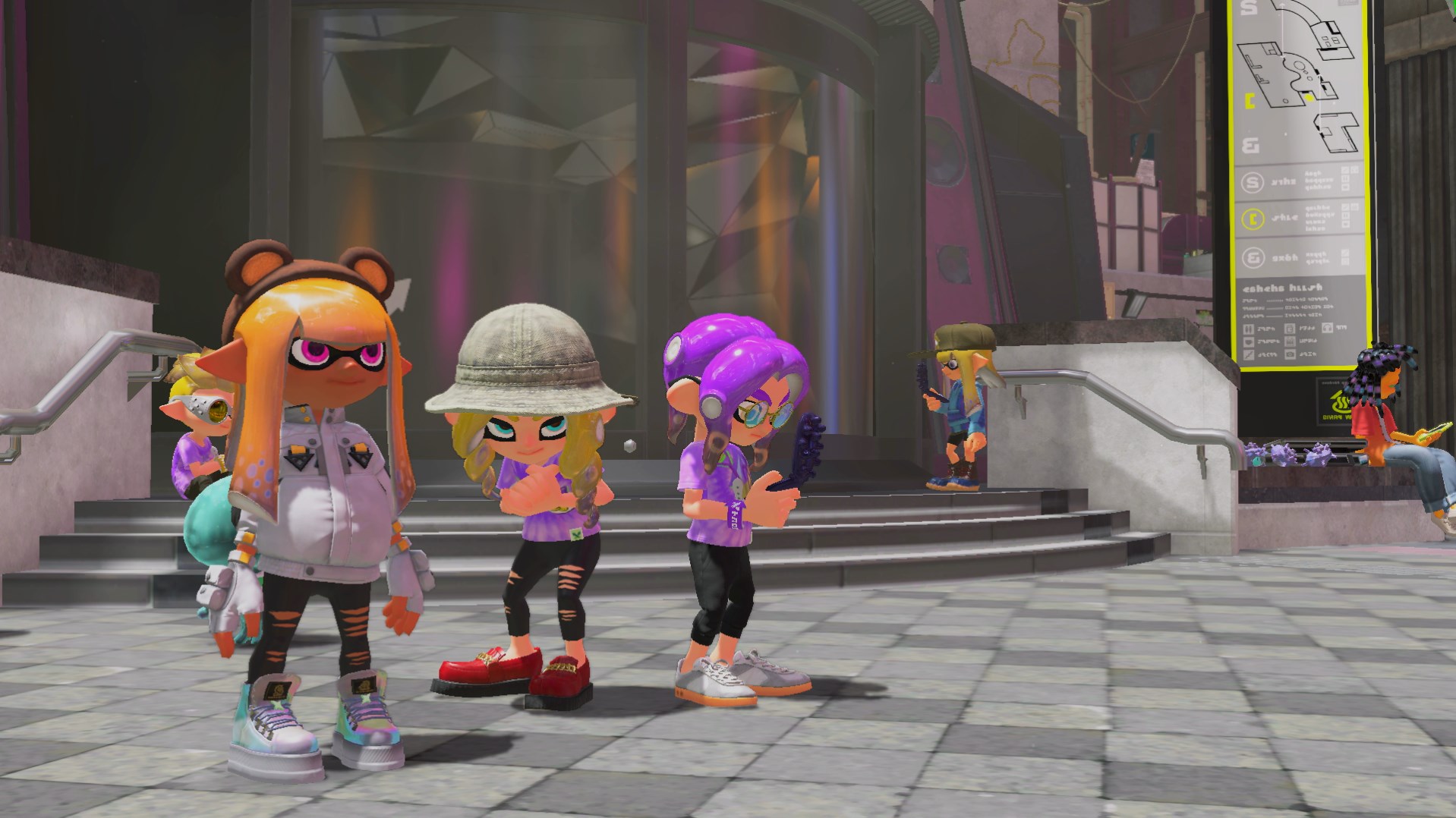 One inkling and two octolings stand in front of a lobby. The two octolings are in Splatfest Tees while the inkling is wearing bear ears and a white puffer jacket