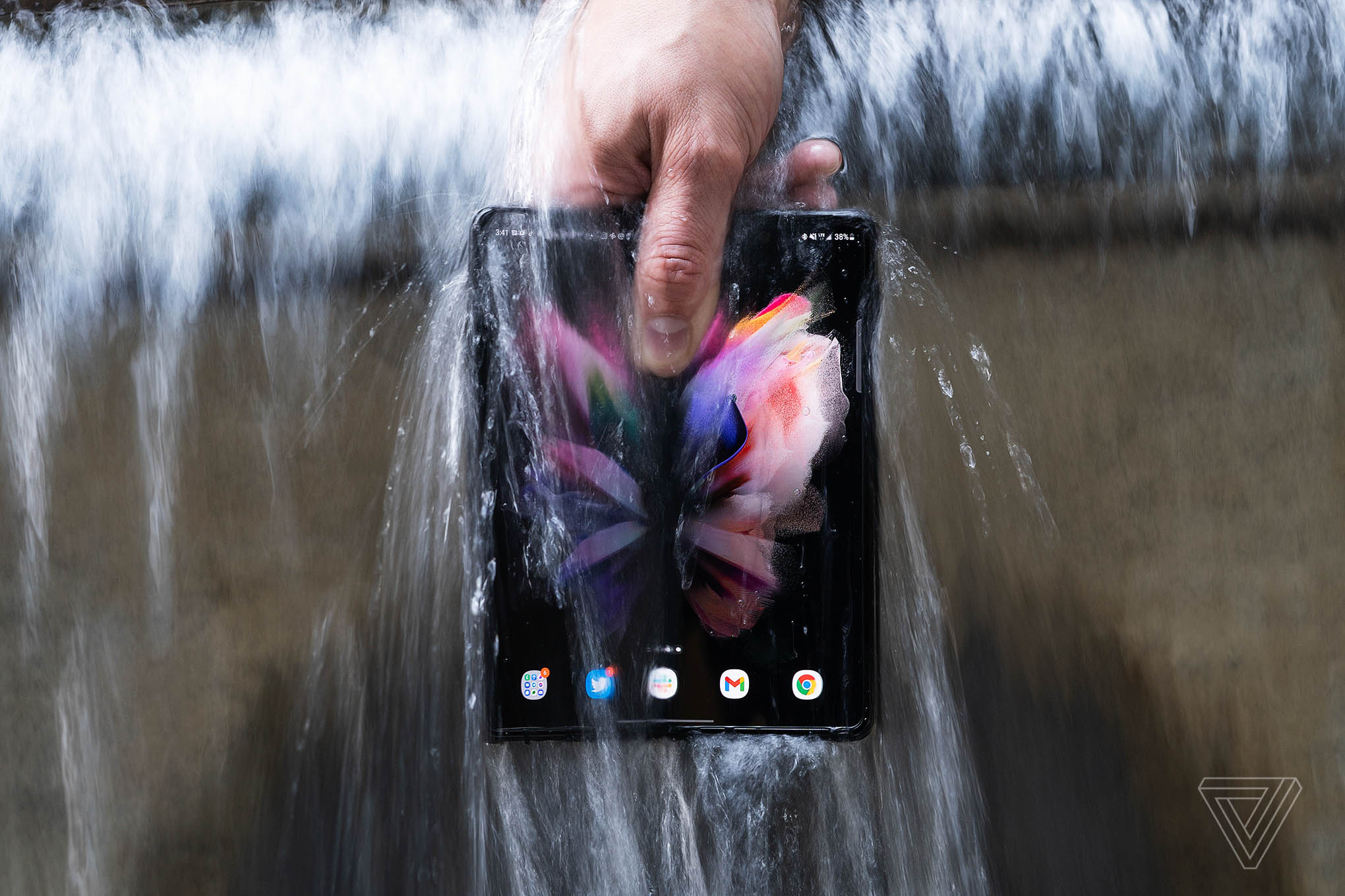 The Samsung Galaxy Z Fold 3 under a waterfall.