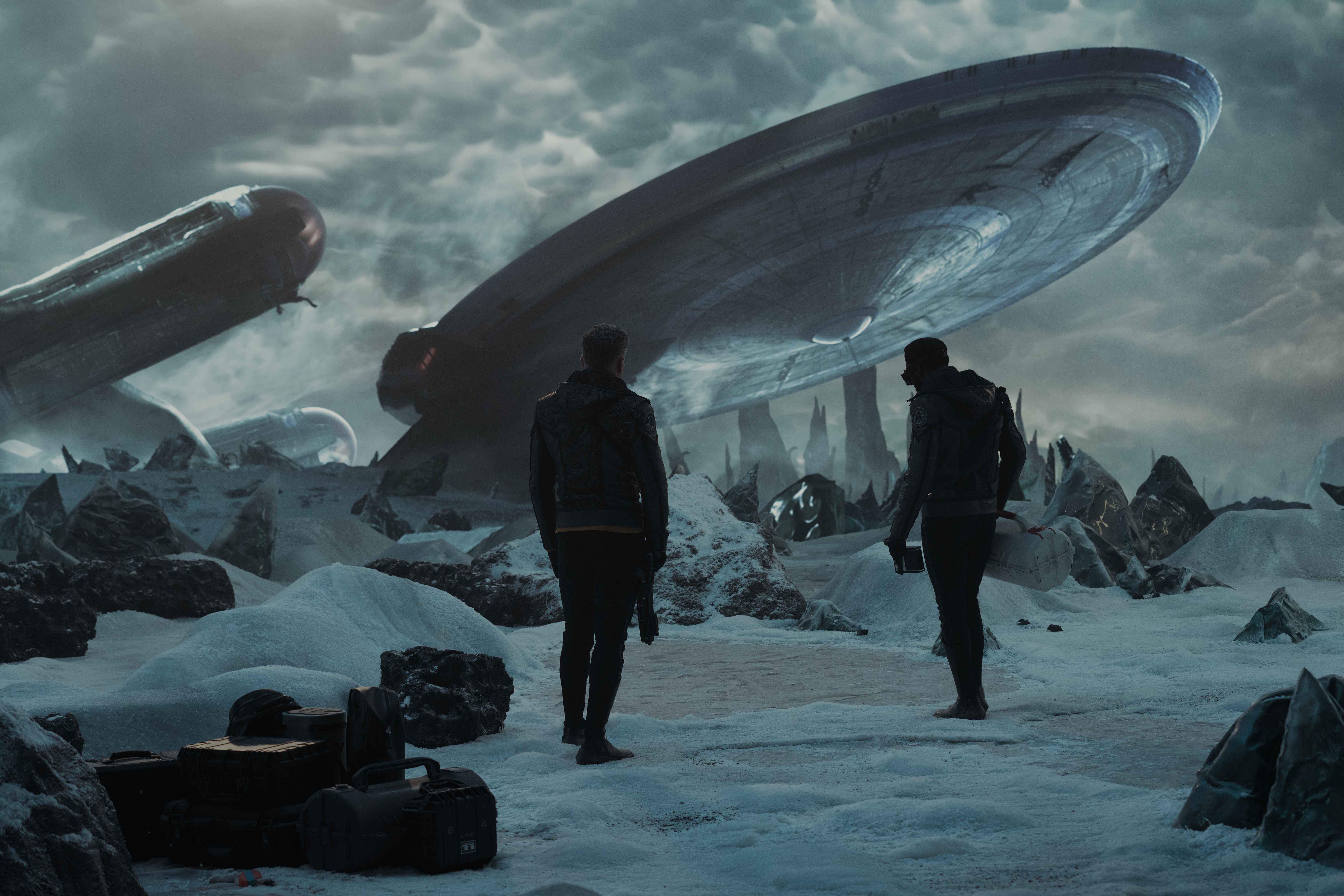 Pike standing with M’Benga on a snowy planet with the Enterprise looming in the background in Star Trek: Strange New Worlds