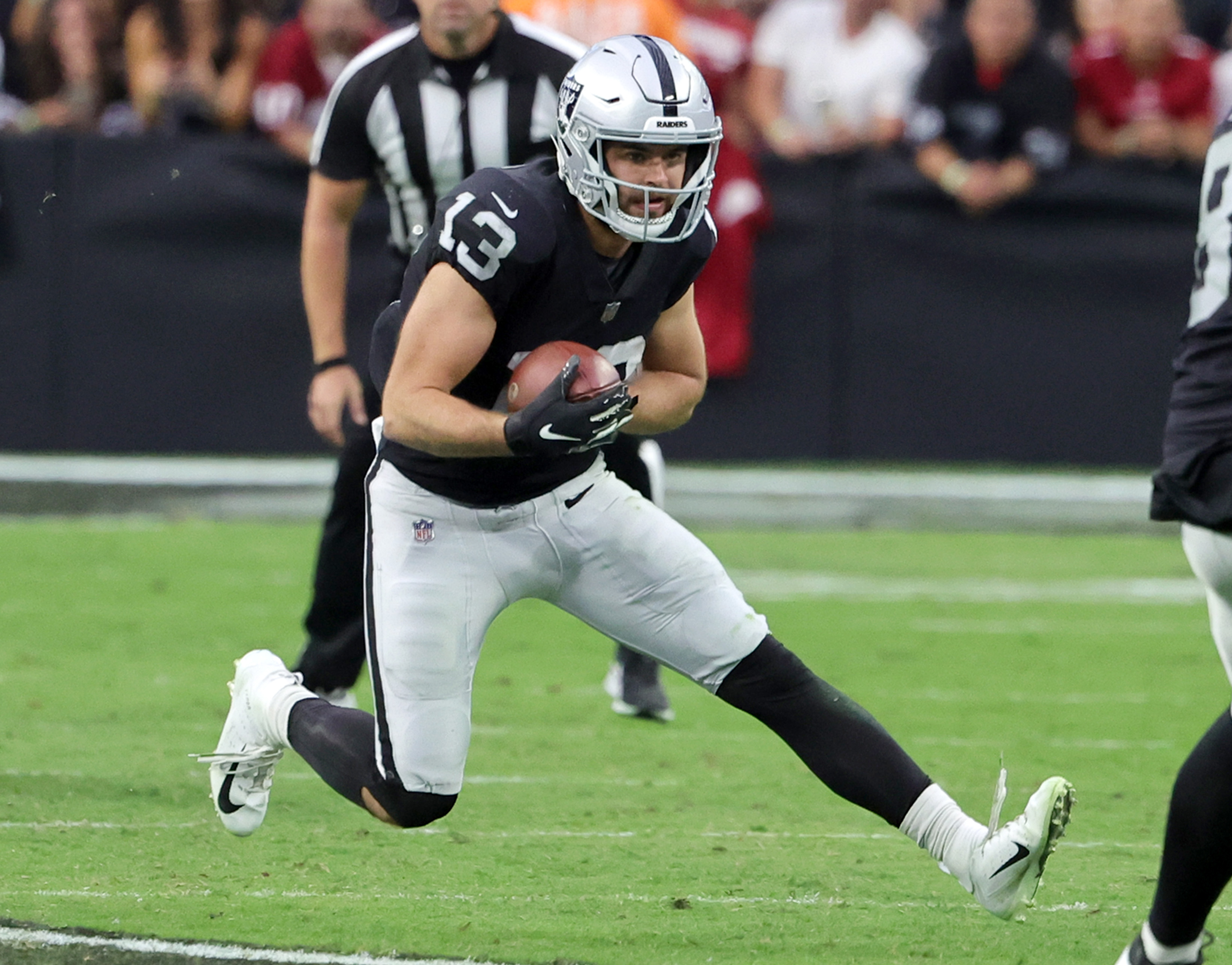Wide receiver Hunter Renfrow #13 of the Las Vegas Raiders carries the ball after a catch against the Arizona Cardinals in overtime of their game at Allegiant Stadium on September 18, 2022 in Las Vegas, Nevada. The Cardinals defeated the Raiders 29-23 in overtime.