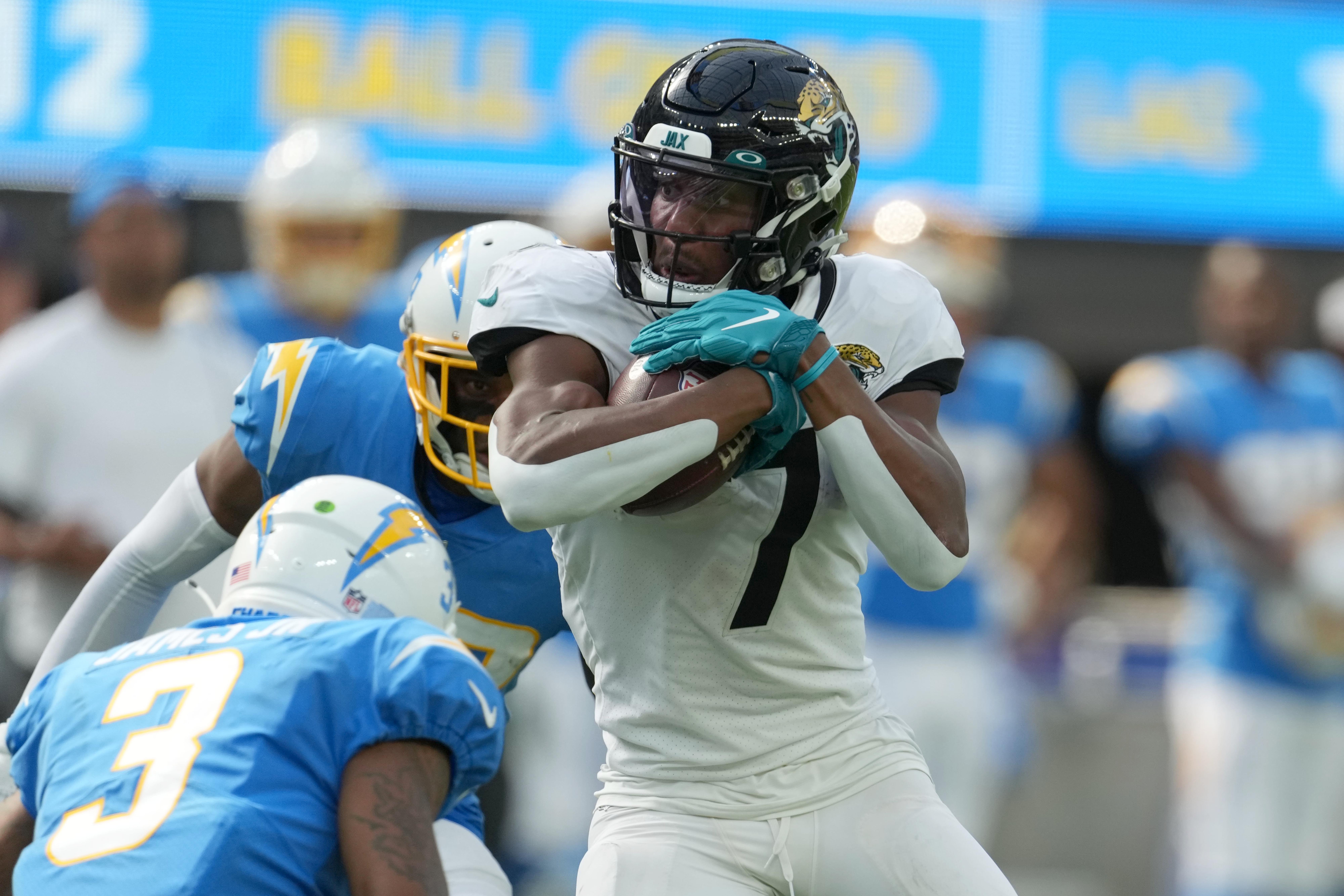 Jacksonville Jaguars wide receiver Zay Jones (7) moves the ball against Los Angeles Chargers safety Derwin James Jr. (3) in the second half at SoFi Stadium.