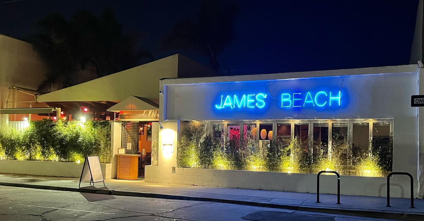 James Beach restaurant front with a neon sign in Venice Beach, California.
