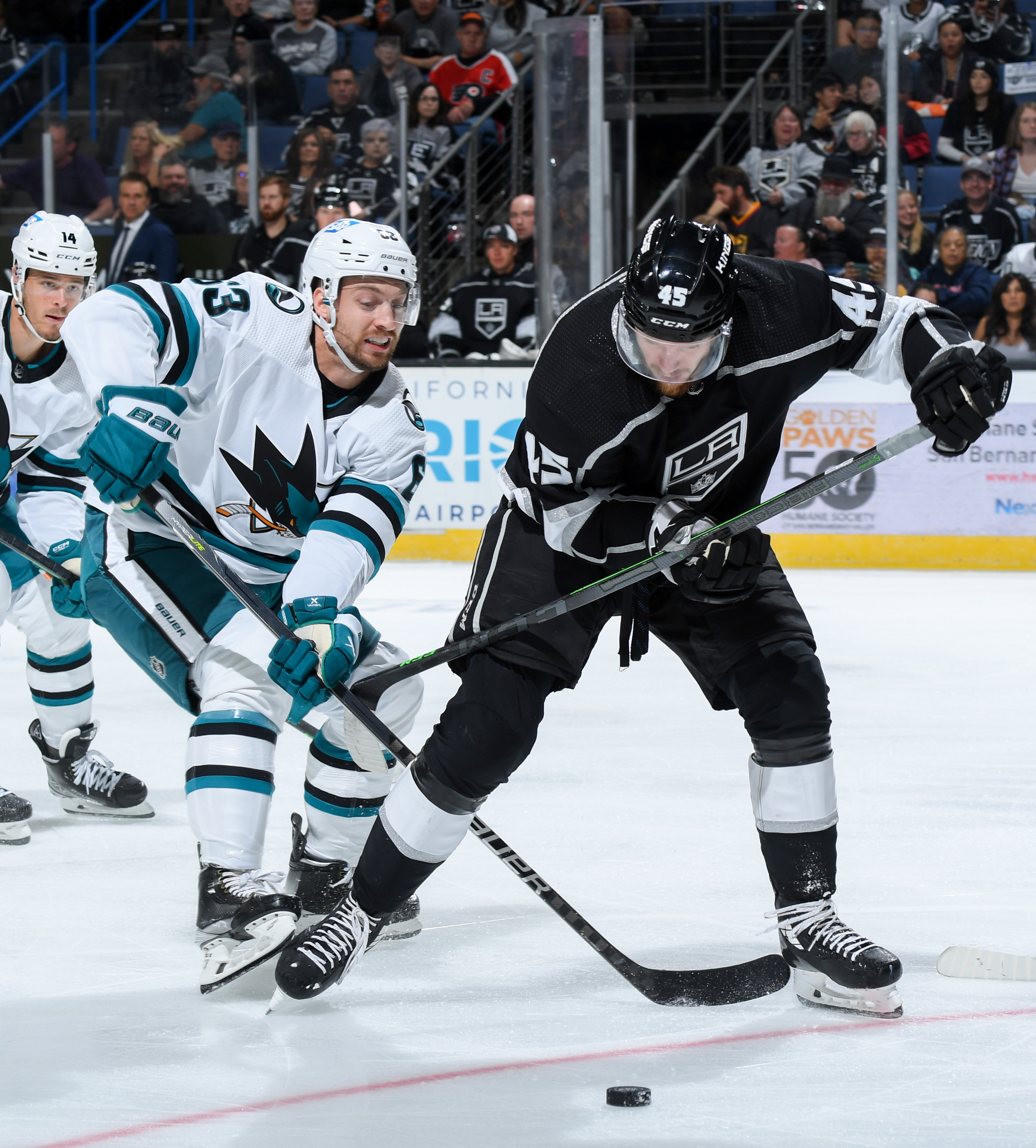 Jeffrey Viel #63 of the San Jose Sharks and Jacob Doty #45 of the Los Angeles Kings battle for position during the second period during the preseason game at Toyota Arena on September 28, 2022 in Ontario, California.