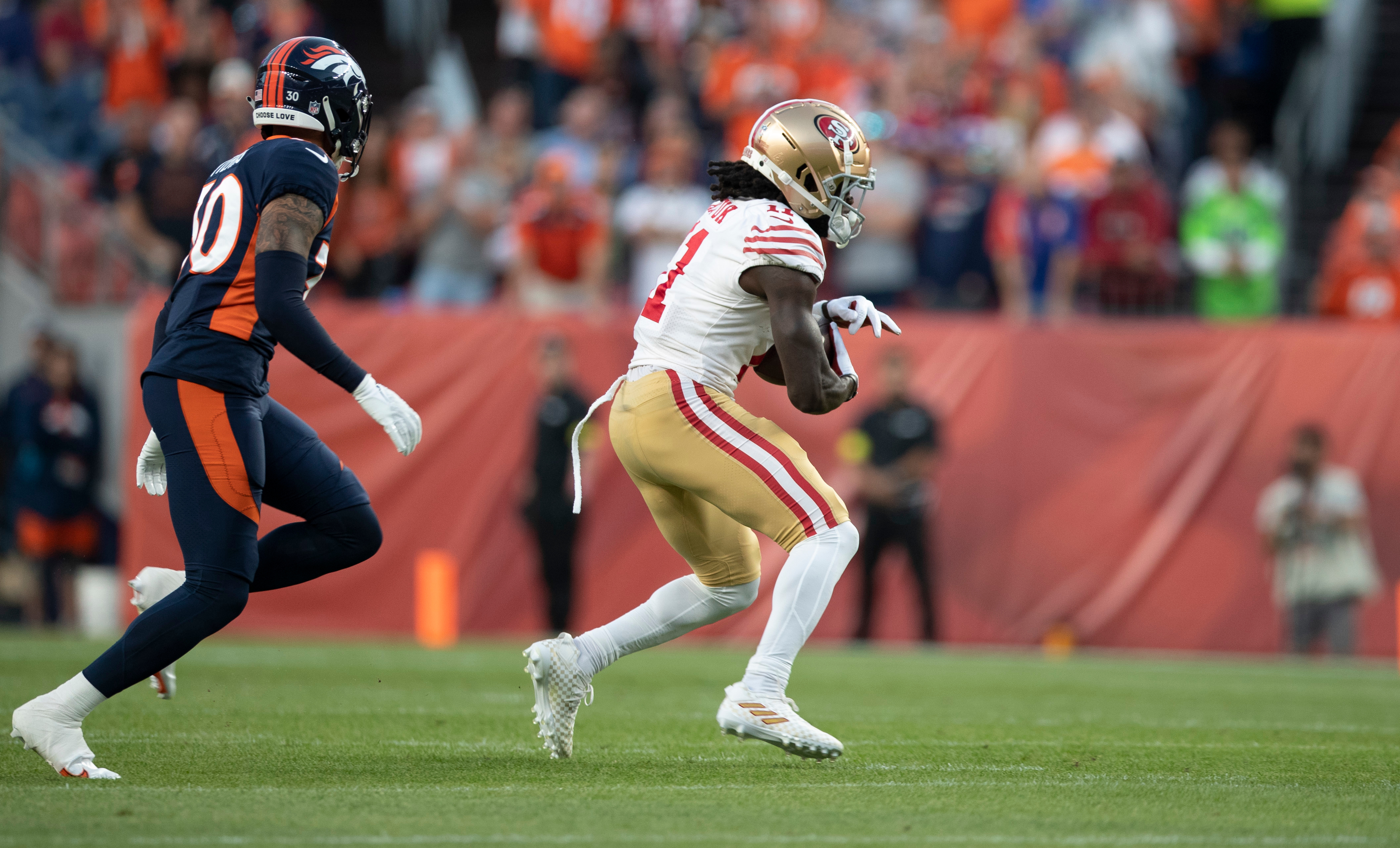 Brandon Aiyuk #11 of the San Francisco 49ers runs after making a catch during the game against the Denver Broncos at Empower Field At Mile High on September 25, 2022 in Denver, Colorado.