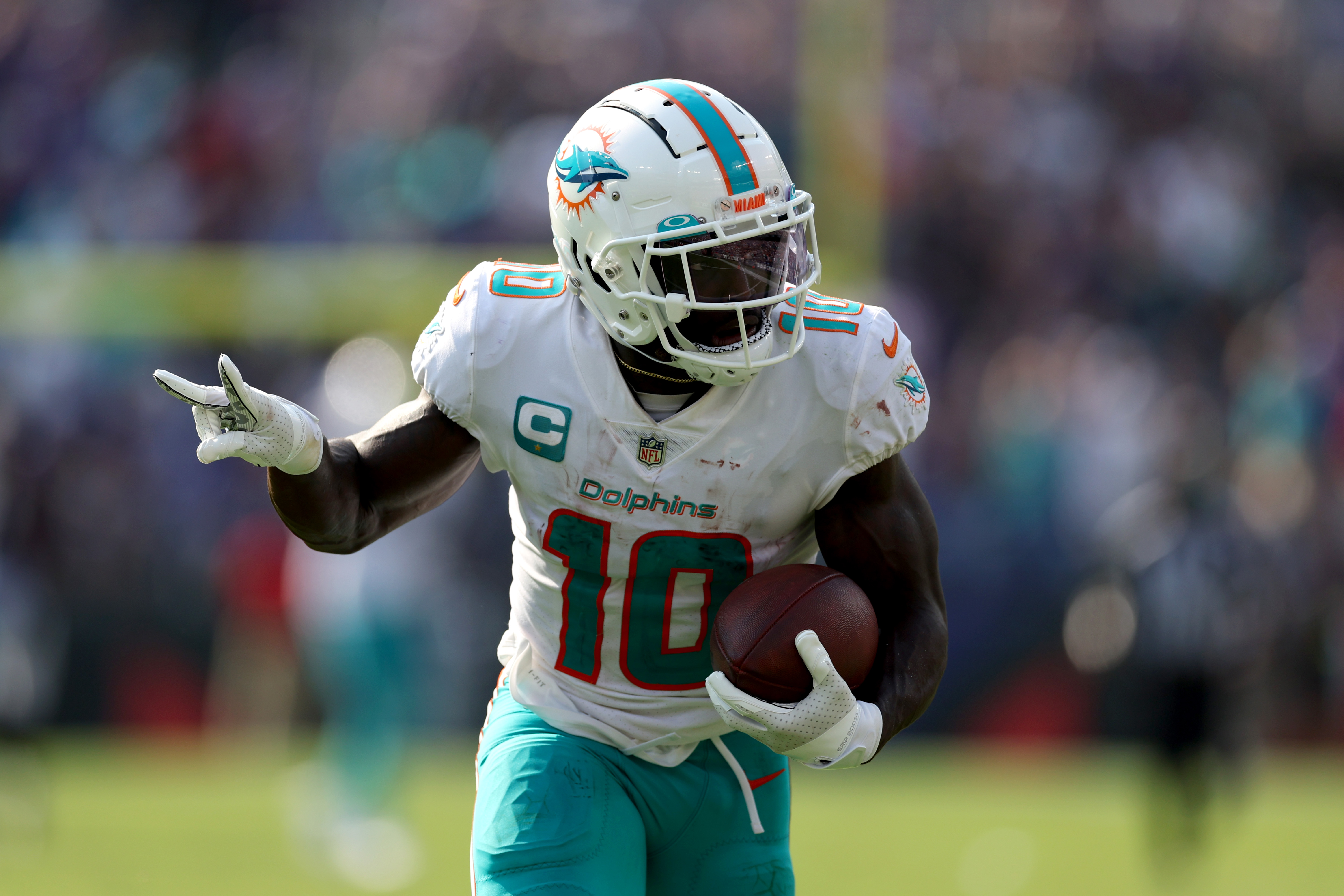 BALTIMORE, MARYLAND - SEPTEMBER 18: Wide receiver Tyreek Hill #10 of the Miami Dolphins celebrates while scoring his second pass touchdown against the Baltimore Ravens at M&amp;T Bank Stadium on September 18, 2022 in Baltimore, Maryland.