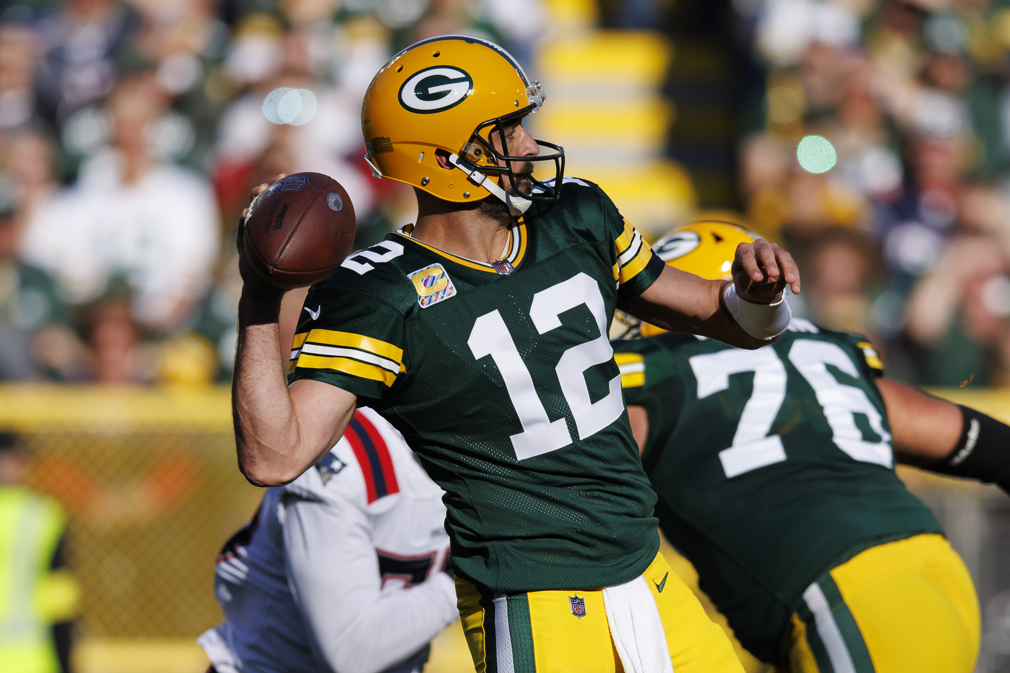 Green Bay Packers quarterback Aaron Rodgers (12) throws a pass during the second quarter against the New England Patriots at Lambeau Field.
