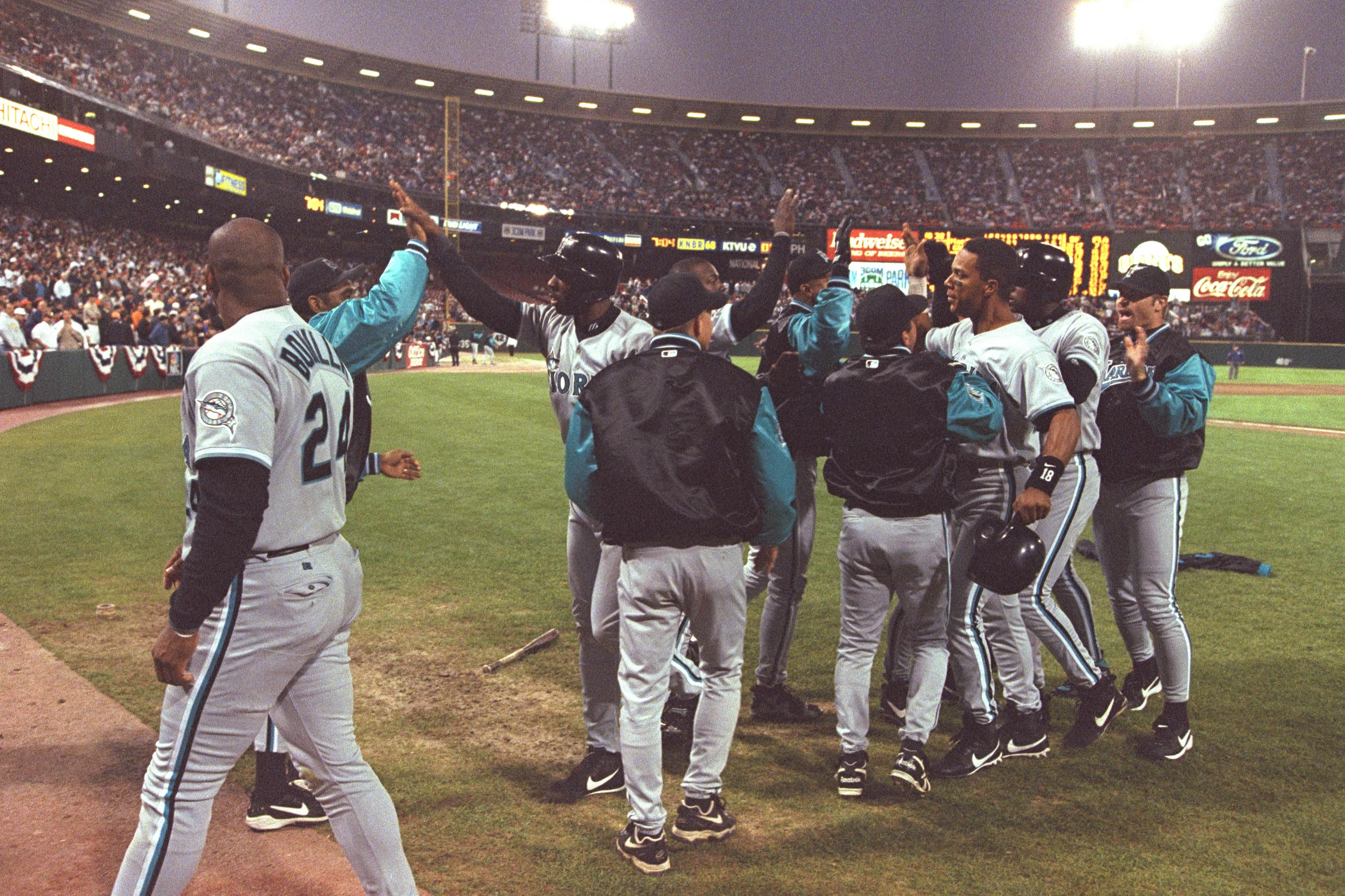 Florida Marlins players celebrate Devon White’s grand slam home run against the San Francisco Giants on Oct. 3, 1997 at Candlestick Park in San Francisco. The Marlins beat the Giants 6-2 to sweep their N.L. Division Series in three games.