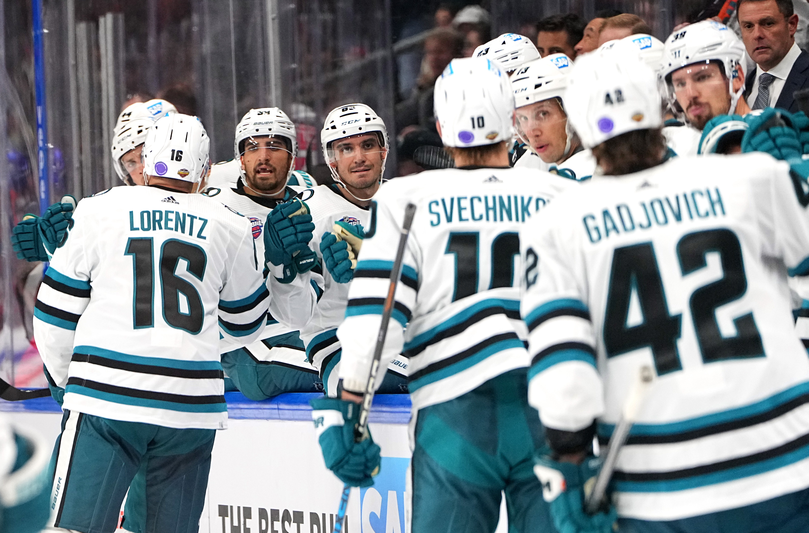 BERLIN, GERMANY - OCTOBER 04: Steven Lorentz #16 of the San Jose Sharks celebrates his goal with teammates during the second period of the NHL Global Series Challenge Germany game against Eisbaren Berlin at Mercedes-Benz Arena on October 04, 2022 in Berlin, Germany.  &nbsp;   