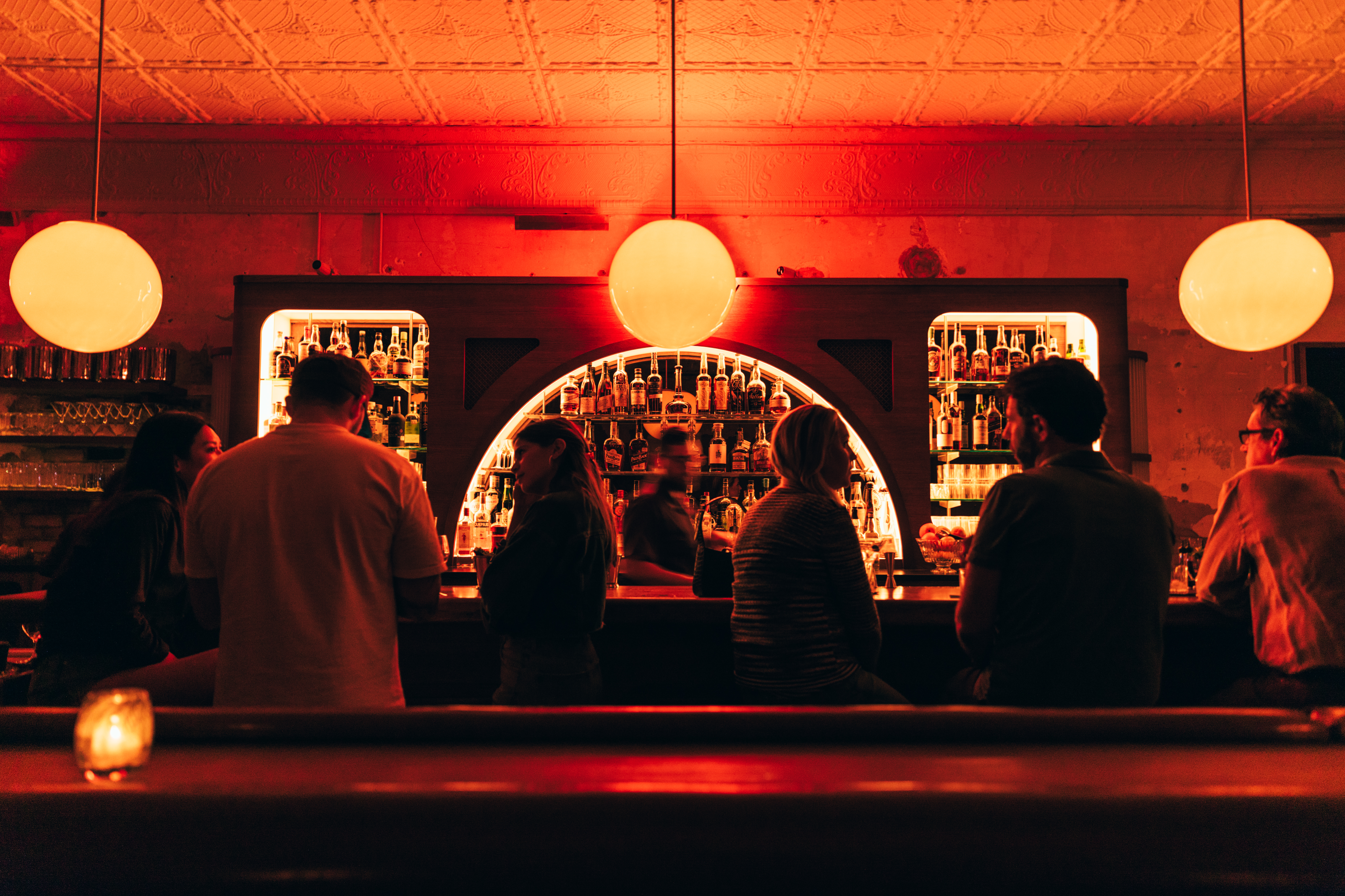 A red-lit bar with people.