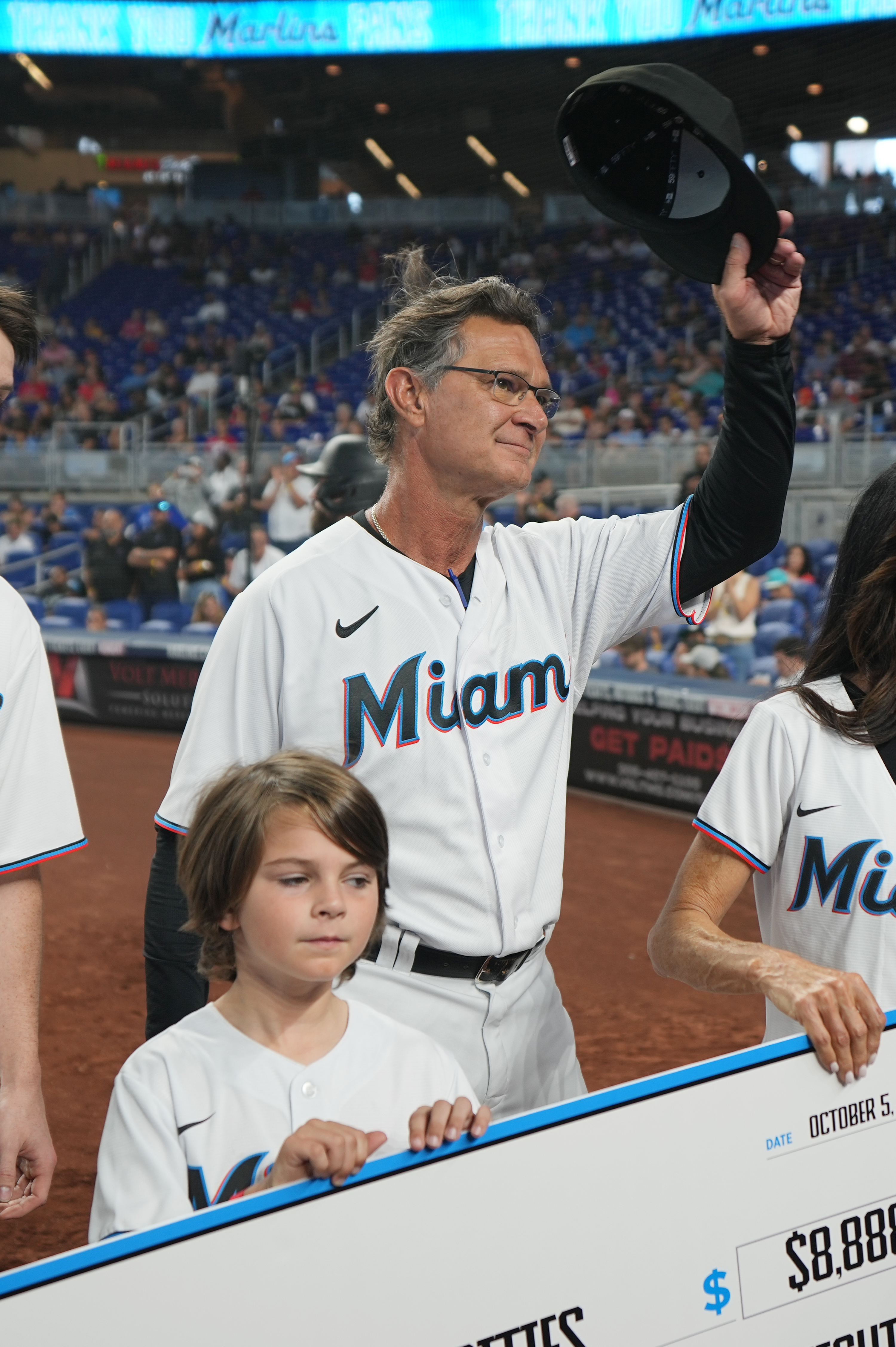 Miami Marlins manager Don Mattingly (8) tips his cap to the fans during a ceremony with his family in the fifth inning at loanDepot Park. Mattingly said he would not return next season.&nbsp;
