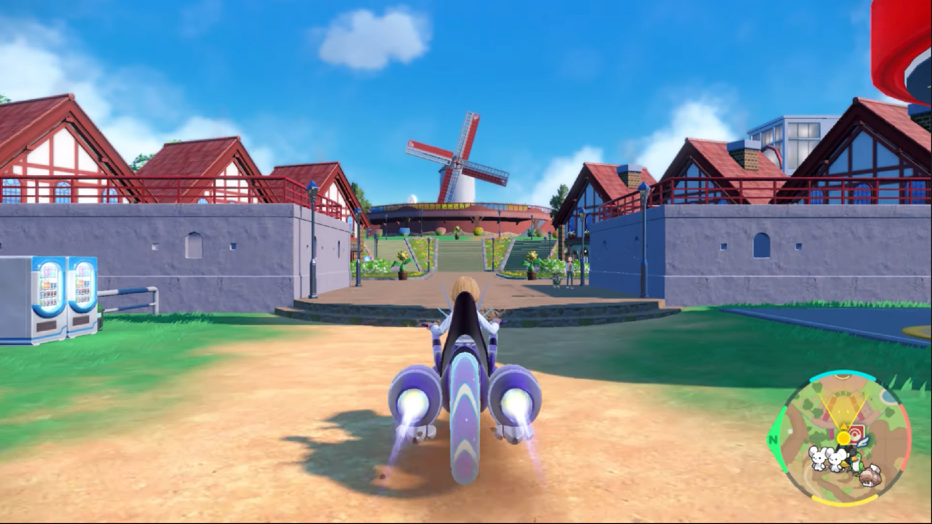 A Pokemon trainer riding a Miraidon into a European village. The mini map on the bottom right shows three new Pokemon.