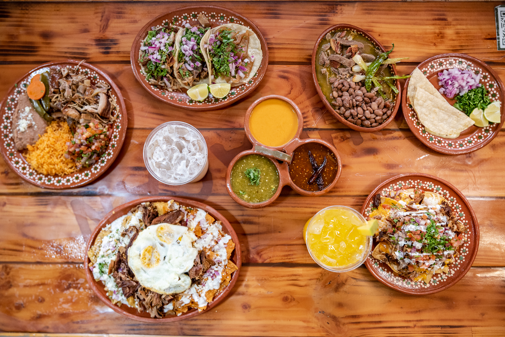 Carnitas-topped tacos, chilaquiles, nachos, and more from Carnitas El Artista.
