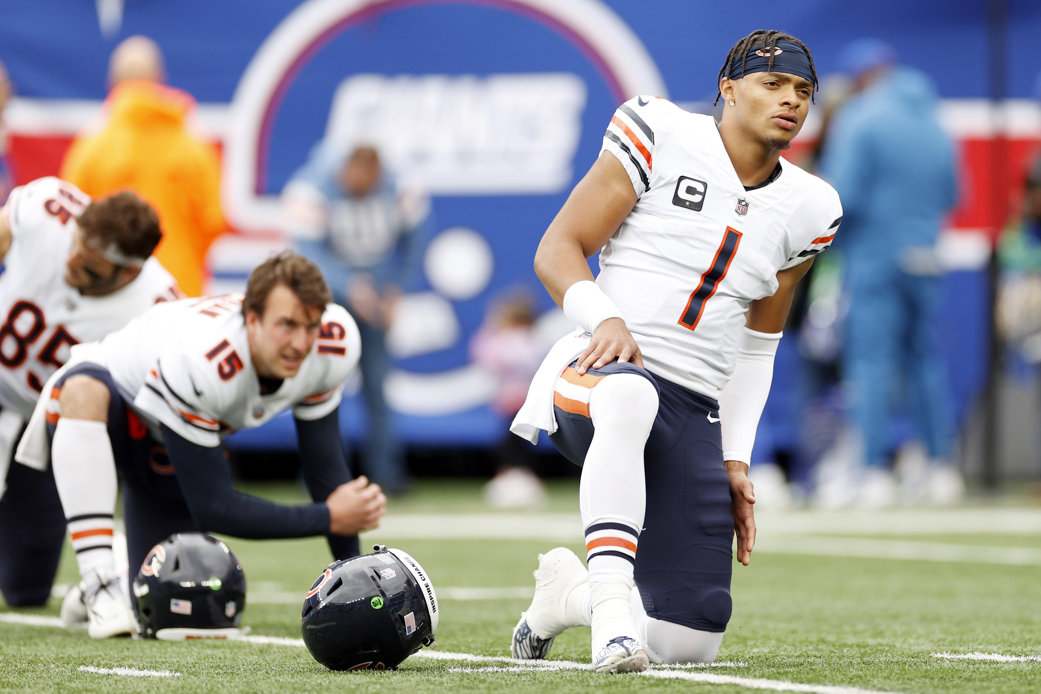 Justin Fields #1 of the Chicago Bears looks on while stretching before the game against the New York Giants at MetLife Stadium on October 02, 2022 in East Rutherford, New Jersey.