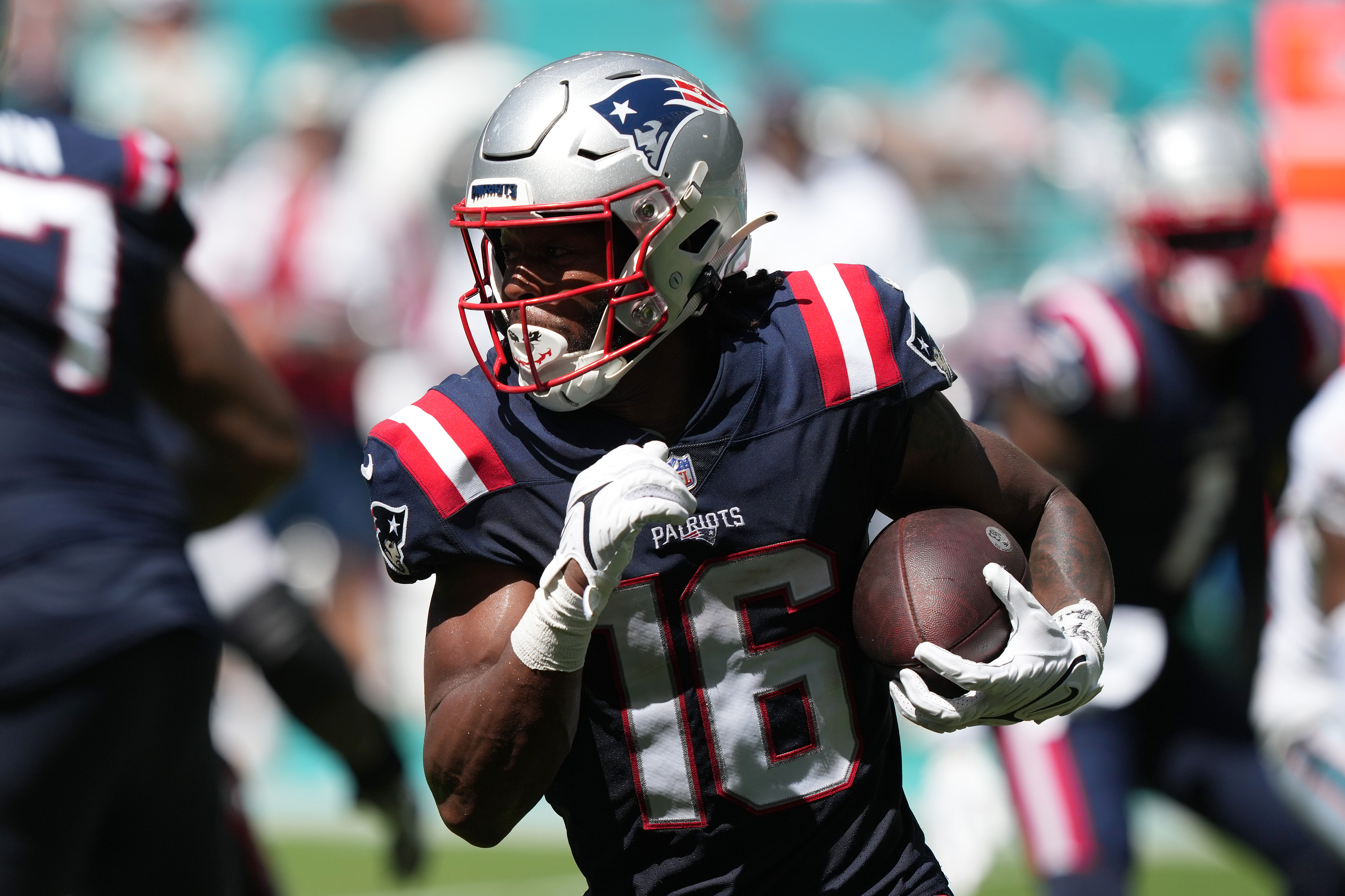Jakobi Meyers #16 of the New England Patriots rushes the football in the fourth quarter of the game against the Miami Dolphins at Hard Rock Stadium on September 11, 2022 in Miami Gardens, Florida.