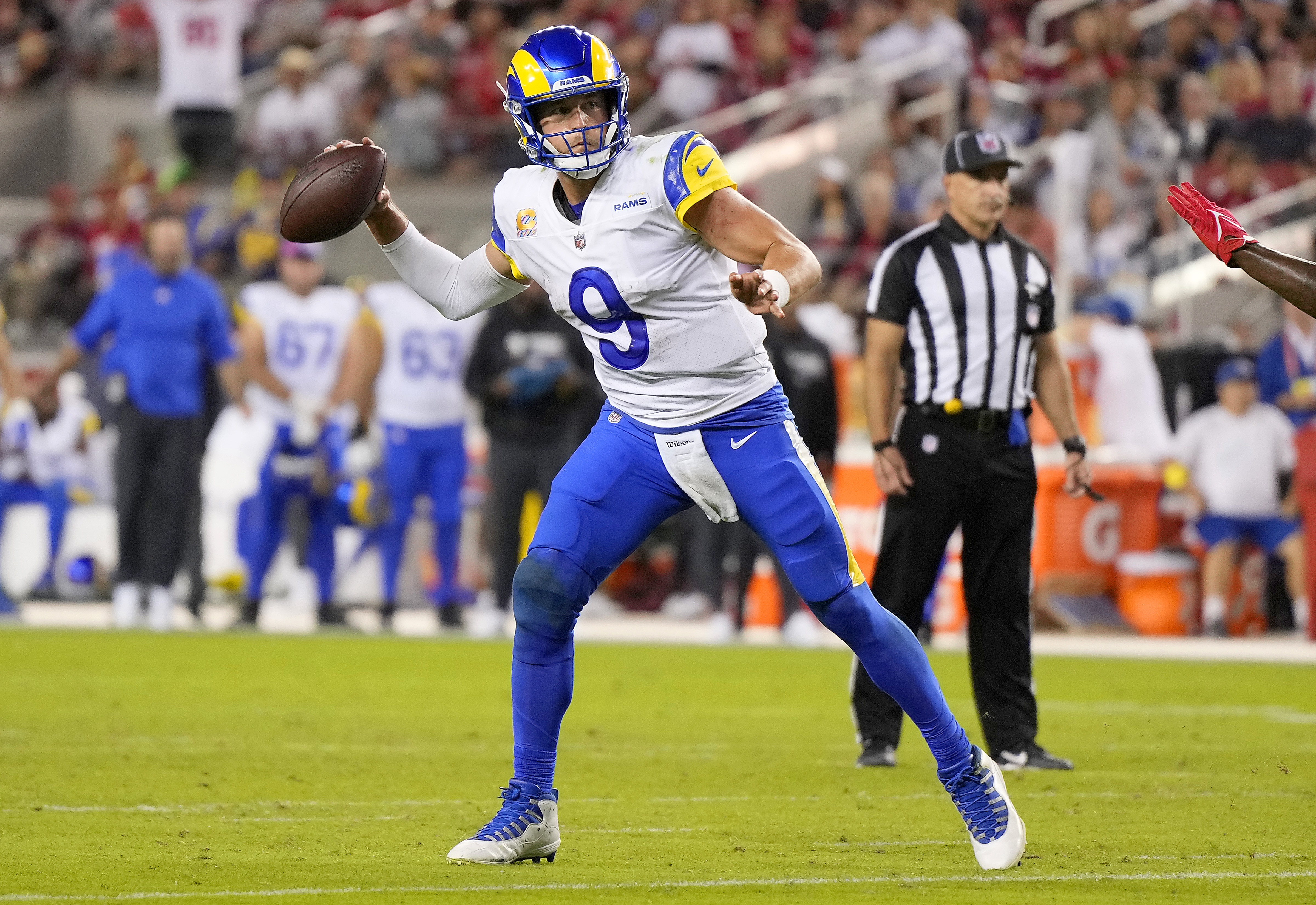 SANTA CLARA, CALIFORNIA - OCTOBER 03: Matthew Stafford #9 of the Los Angeles Rams rolls out looking to pass against the San Francisco 49ers in the third quarter at Levi’s Stadium on October 03, 2022 in Santa Clara, California.
