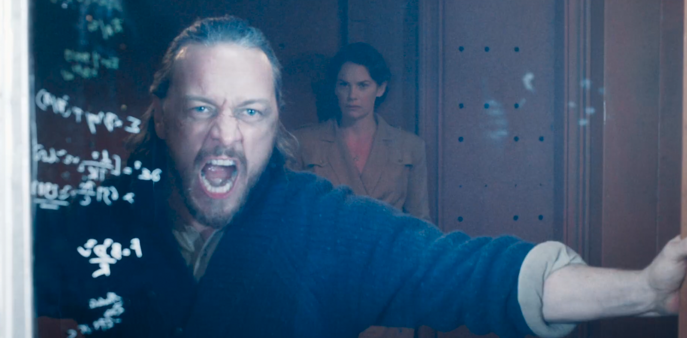 James McAvoy’s Lord Asriel screams as white light flashes and illuminates some math on a board and a white brunette lady stands behind him going “oh my” in His Dark Materials season 3